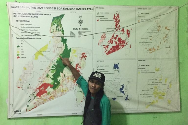 Director of Walhi in South Kalimantan, Kisworo Dwi Cahyono, points to the Batutangga concession area on a map in the Walhi office in Banjarbaru. The Meratus Mountains and Central Hulu Sungai district stand out as the only green spaces in the provinc…