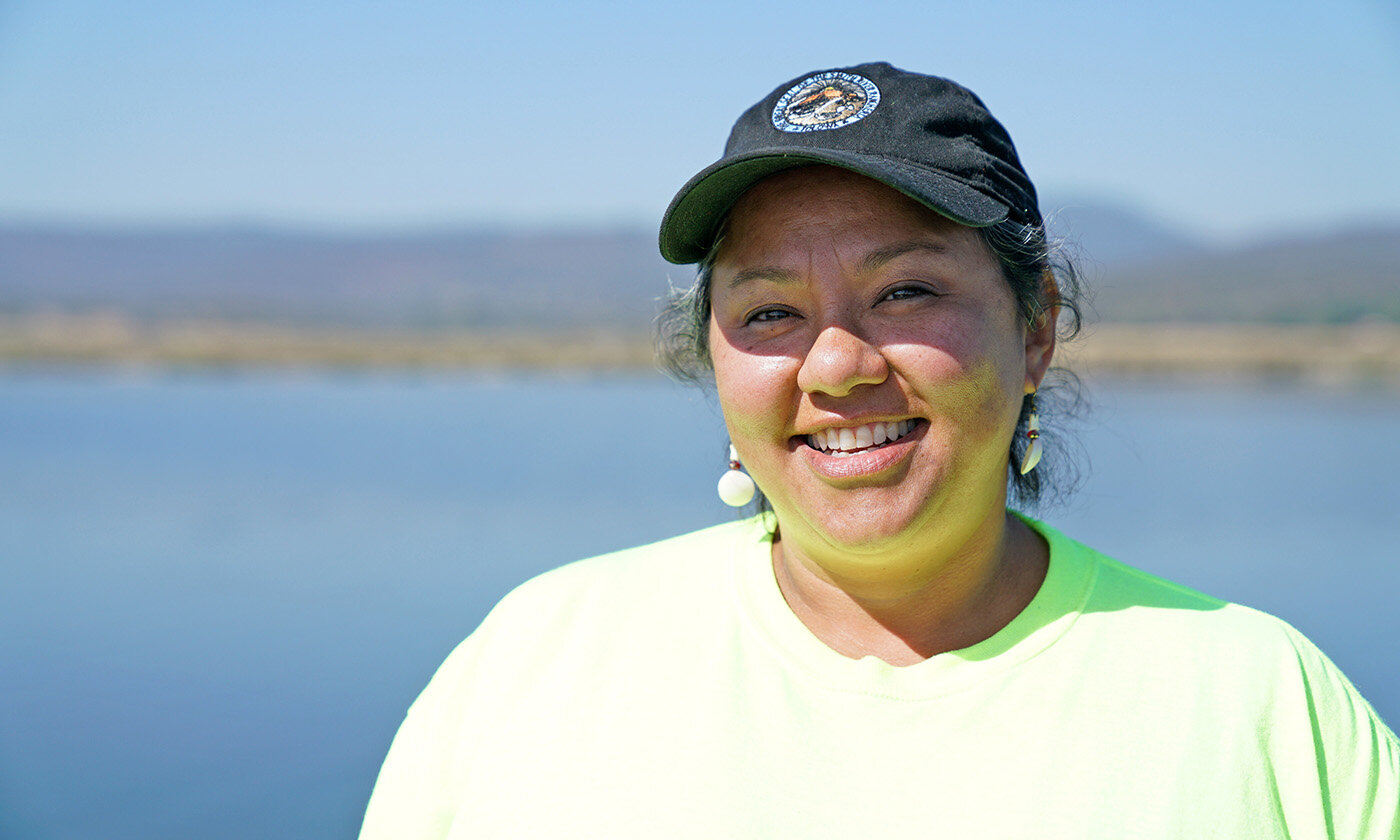 Onna Joseph, a Yurok citizen and a member of the Yurok Fisheries Department seed crew, collects native plant seeds, which will be used to restore the footprint of the Klamath reservoirs after four dams are removed in 2023. The Yurok Tribe has led the dam removal effort since 2002. Photo from the Yurok Tribe.