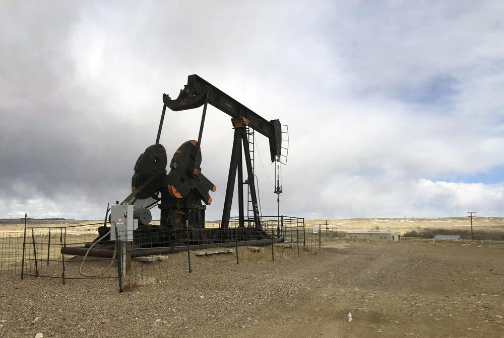 FILE - In this Feb. 26, 2021, file photo, an oil well is seen east of Casper, Wyo. Federal officials have approved thousands of new oil and gas drill permits since President Joe Biden took office in January, disappointing environmentalists who want a ban against drilling on federal lands. (AP Photo/Mead Gruver, File)