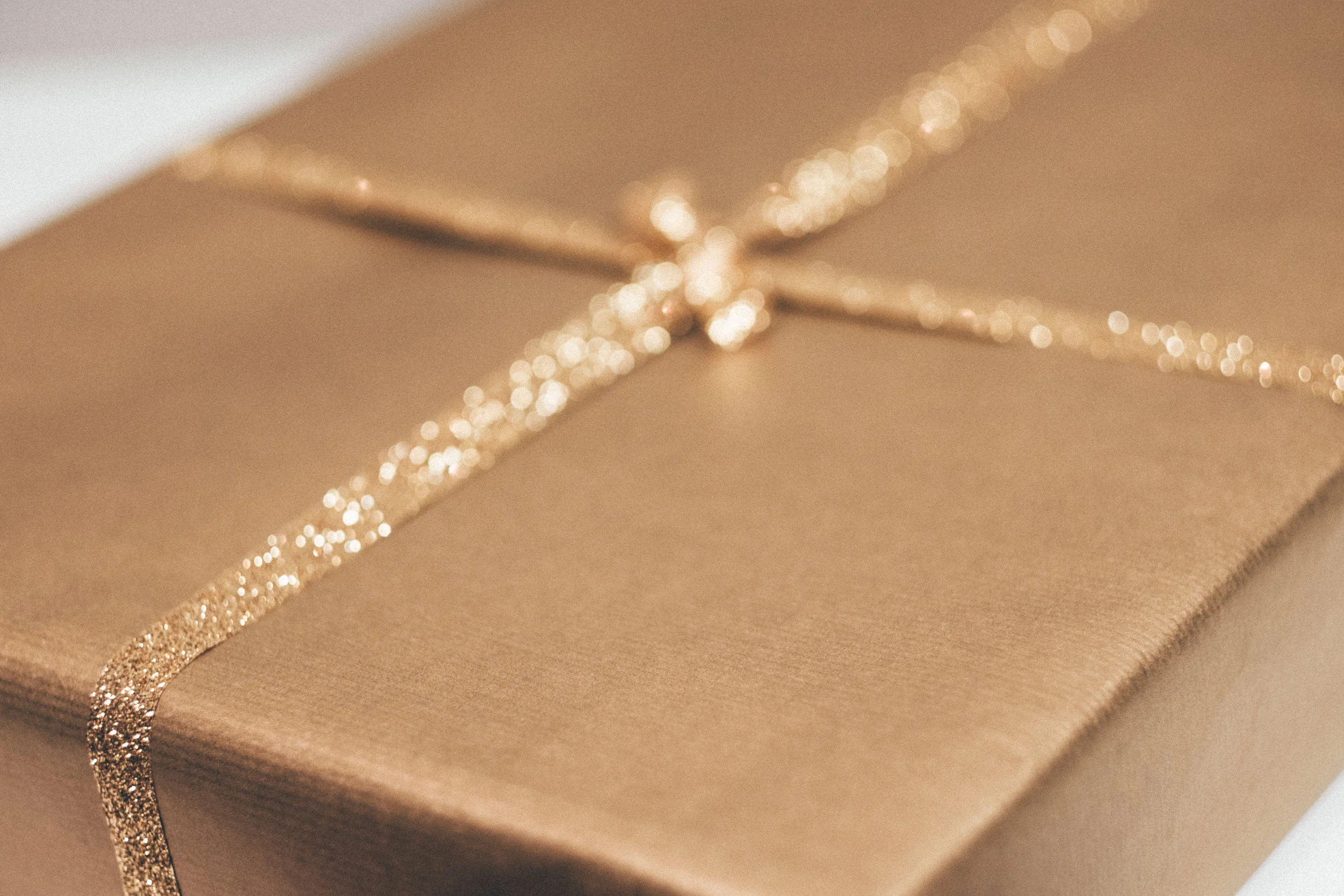 Gift box representing the gift someone may give you to help cover your down payment, closing costs, prepaids or escrows when getting a mortgage.
