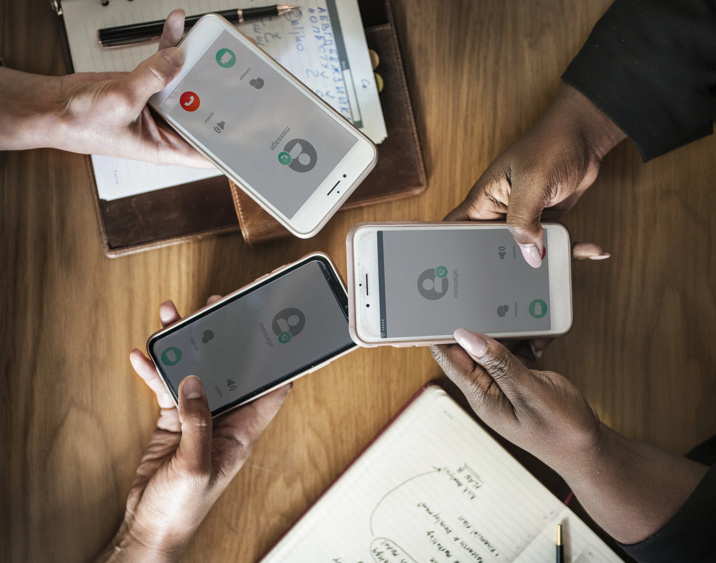 Three people holding out their cell phones and adding each other to contact list. Could be the start of their home buying process!