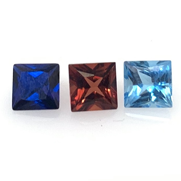 Left to Right: Lab Created Blue Sapphire, Garnet, and Blue Topaz