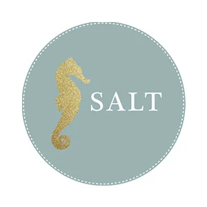 A circular logo with a gold seahorse on the left and the word 'SALT' on the right, set against a light blue background.