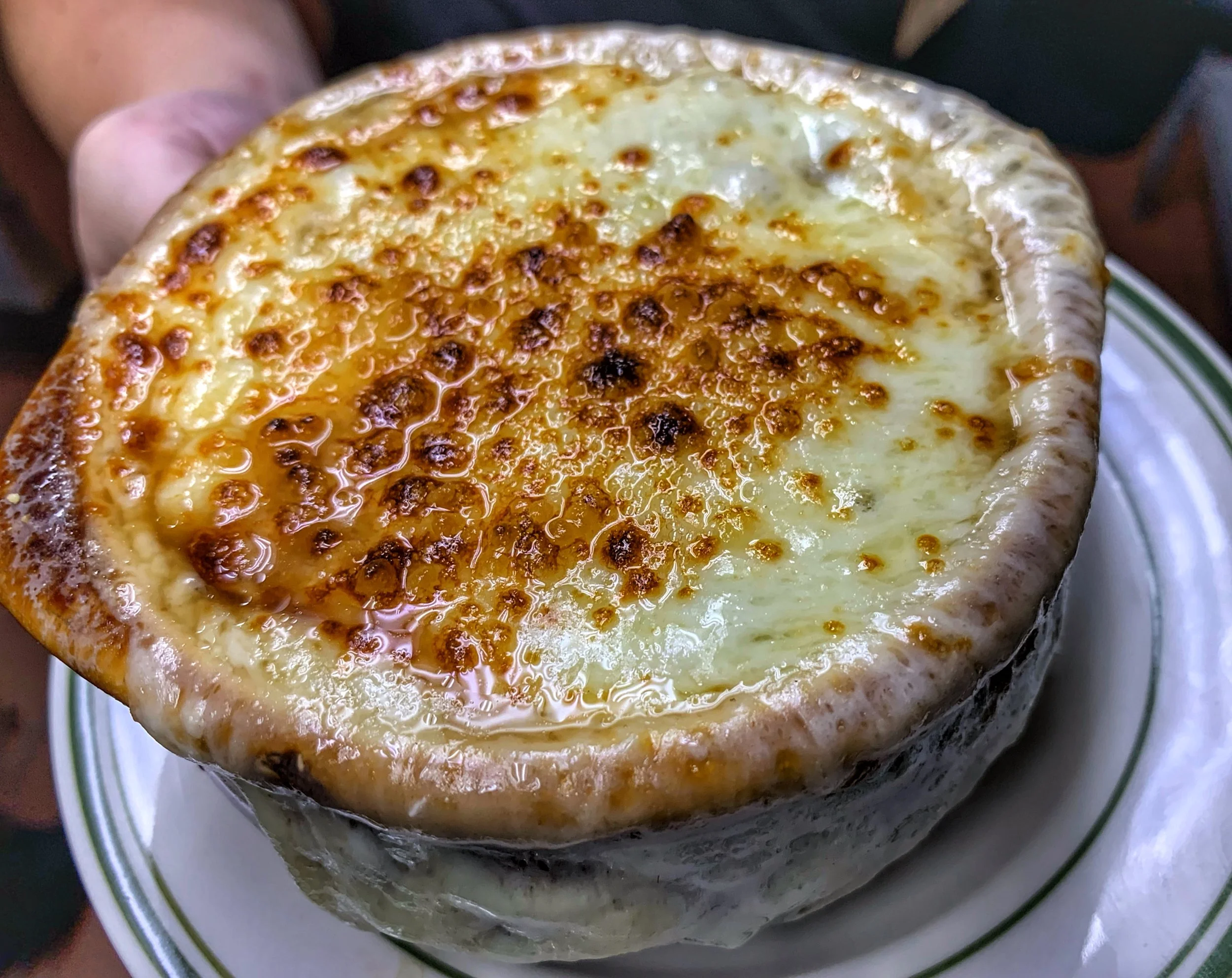 Classic French Onion Crock at John & Molly's Tavern in Eastampton, NJ – rich broth filled with caramelized onions, topped with thick, melted Gruyère-style cheese that's golden-brown and bubbly, served in a traditional crock with a toasted bread layer