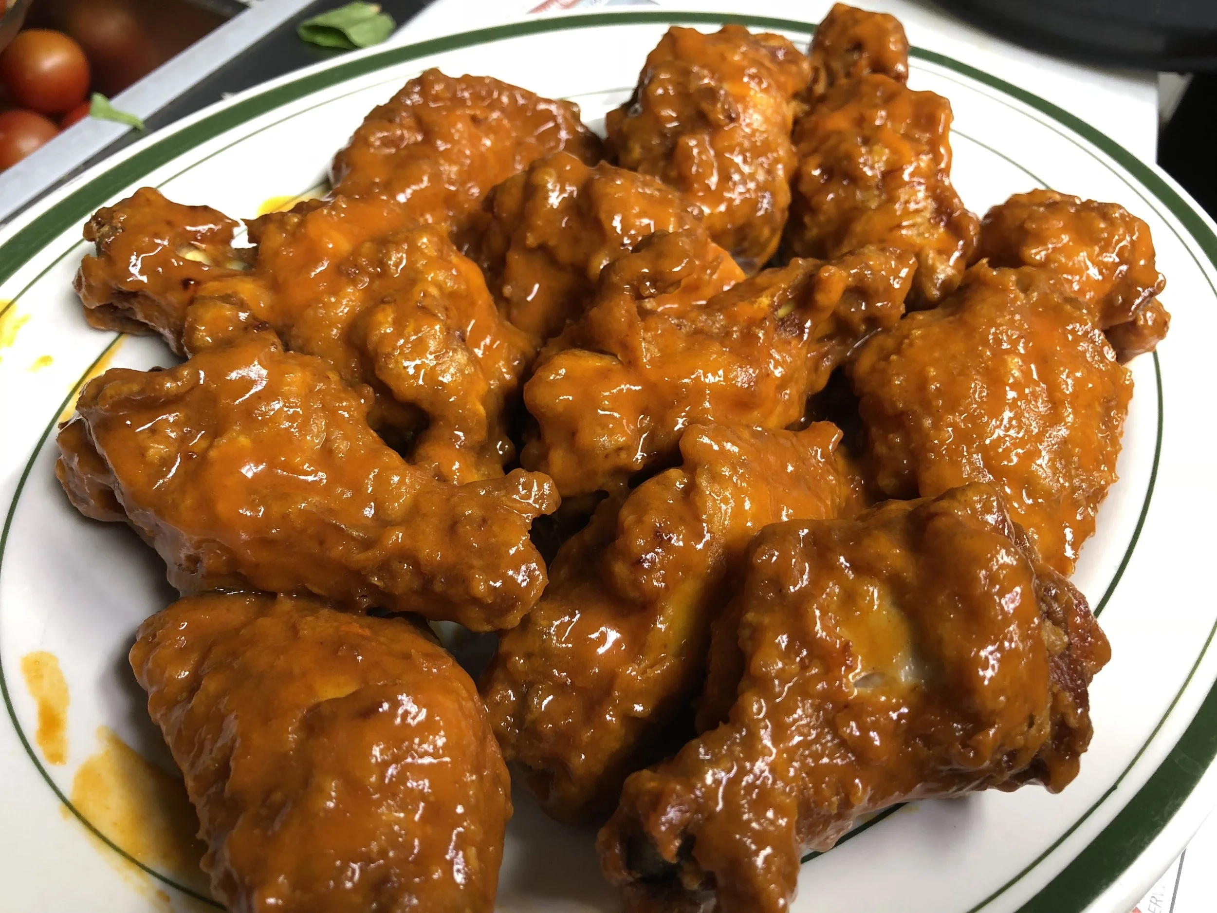 Pile of crispy jumbo buffalo wings coated in classic spicy buffalo sauce at John & Molly's Tavern in Eastampton, NJ – award-winning, fresh, and served hot with a glossy glaze.