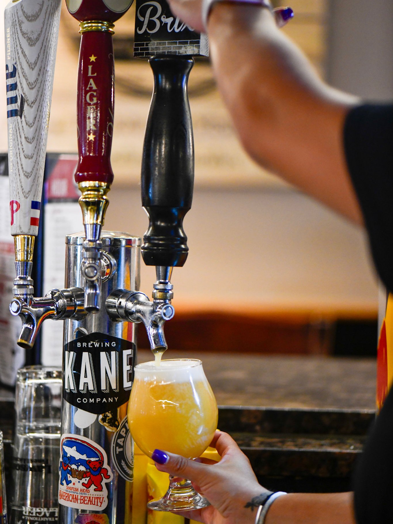 Bartender pouring a fresh draft of Kane Brewing Company beer from the tap at John & Molly's Tavern in Eastampton, NJ – showcasing our rotating selection of craft beers on tap, including local NJ favorites.