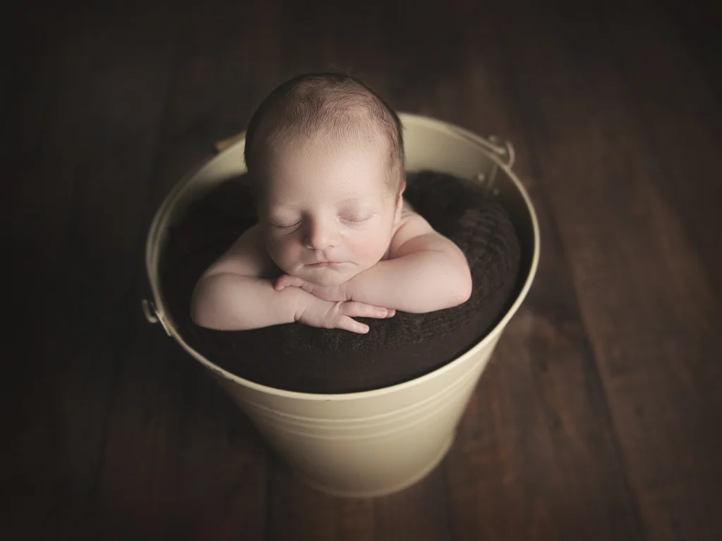 Bucket -head on hands pose. Most parents love this pose as you can see the beautiful little face perfectly.