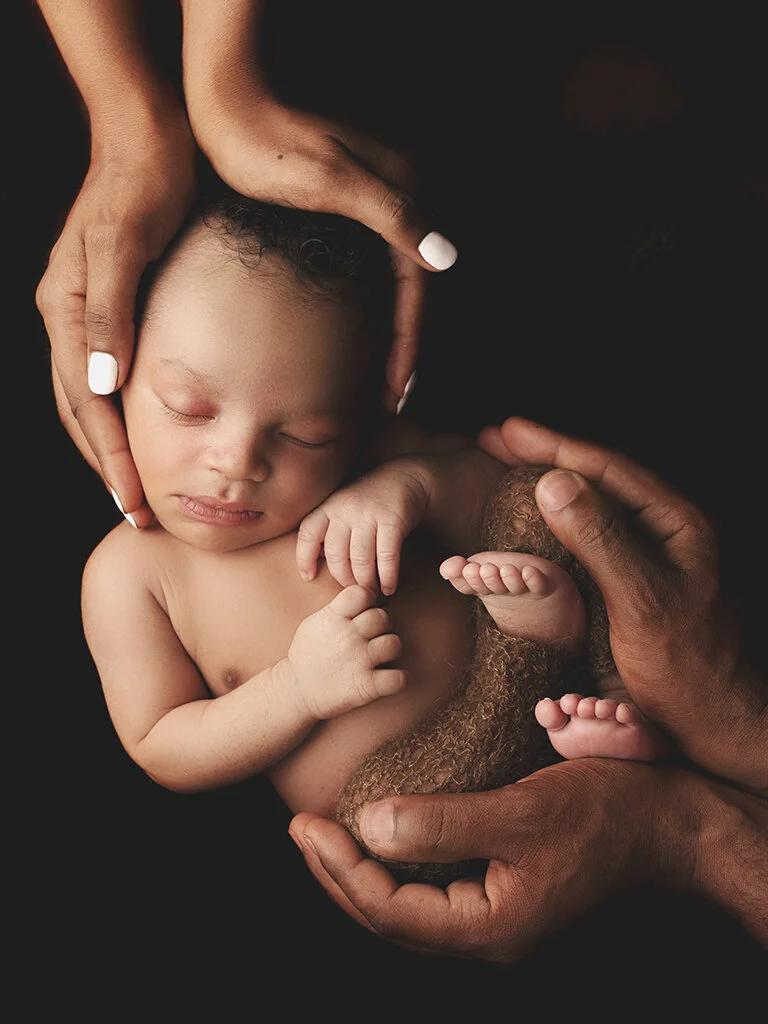in-mom-and-dads-hands.jpg
