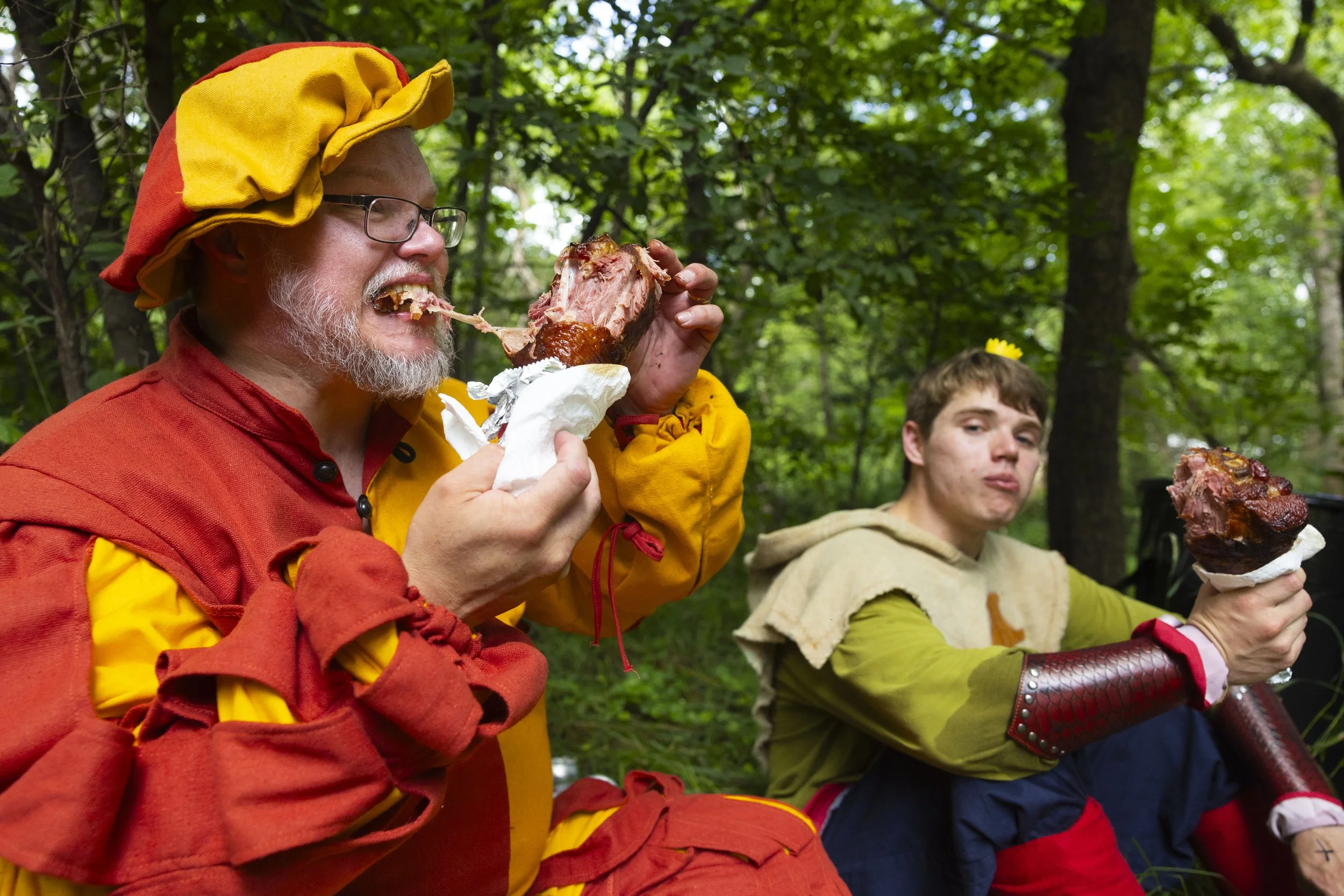York residents James Turner, left, and his son Cameron dig into turkey legs during the Lincoln Renaissance Festival at the Outdoor Education Center grounds on Saturday, July 26, 2025.
