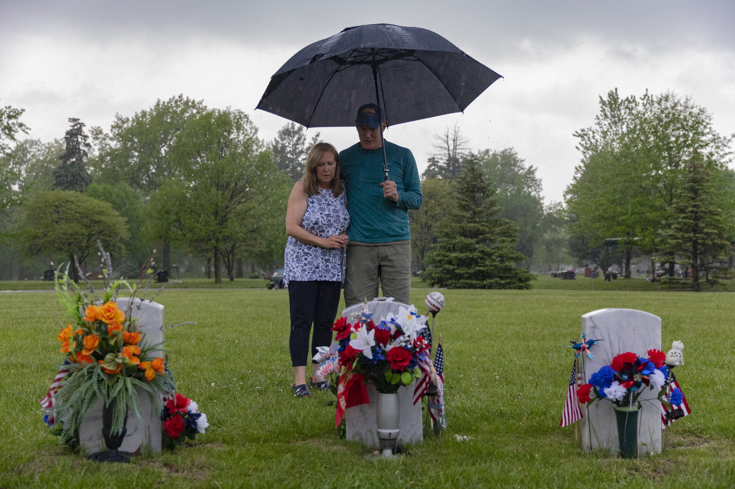  Susan (left) and Bryan Phillips visit the grave of their son Michael Phillips during a heavy downpour before Memorial day on Friday, May 22, 2020, at Wyuka Cemetery. Michael served in the Marine Corps in Morocco, Uganda, and two tours of duty in Ira