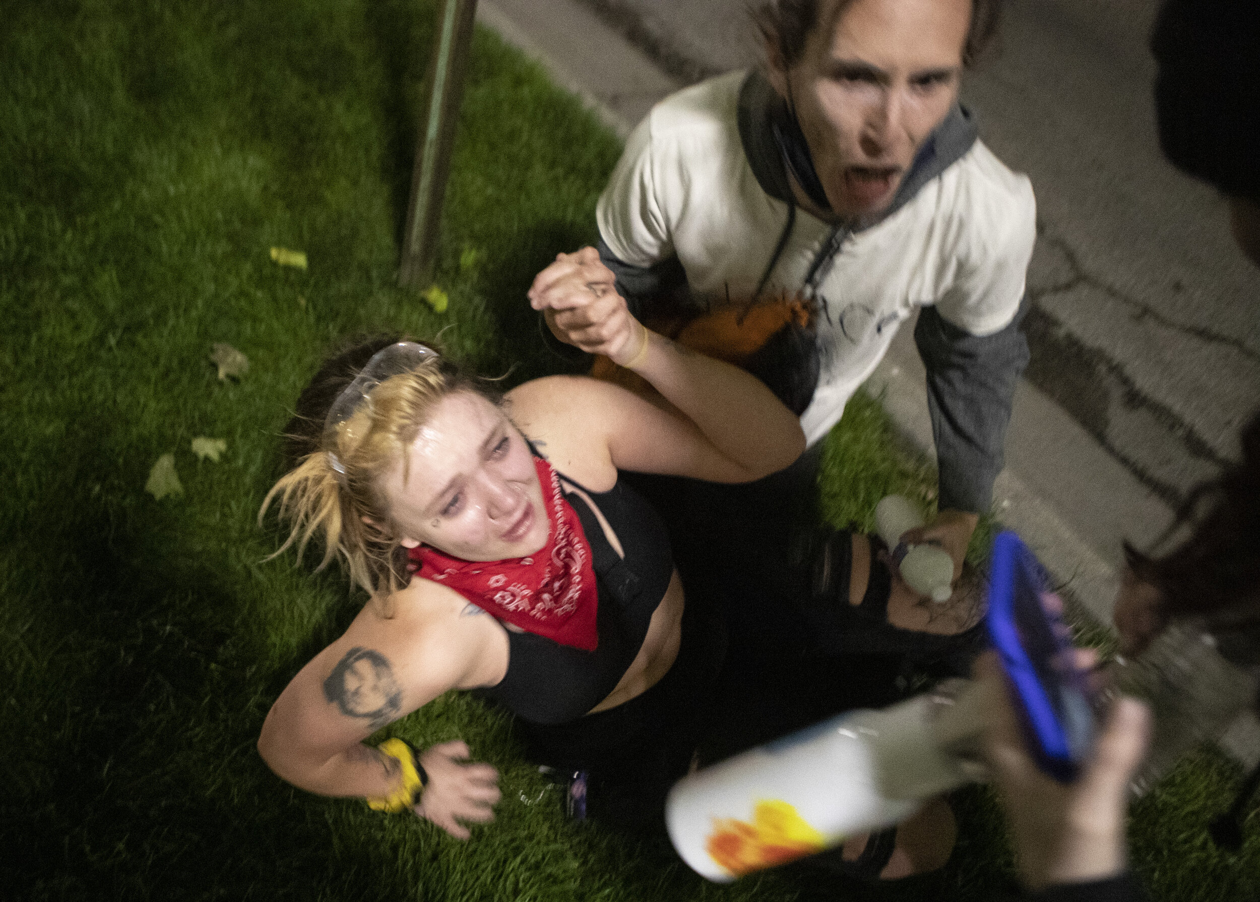  A protester calls for help after their partner was incapacitated by a rubber bullet and tear gas in the Lincoln mall as the second night of peaceful protests against police brutality suddenly turned violent late Saturday night on  May 30, 2020, in L