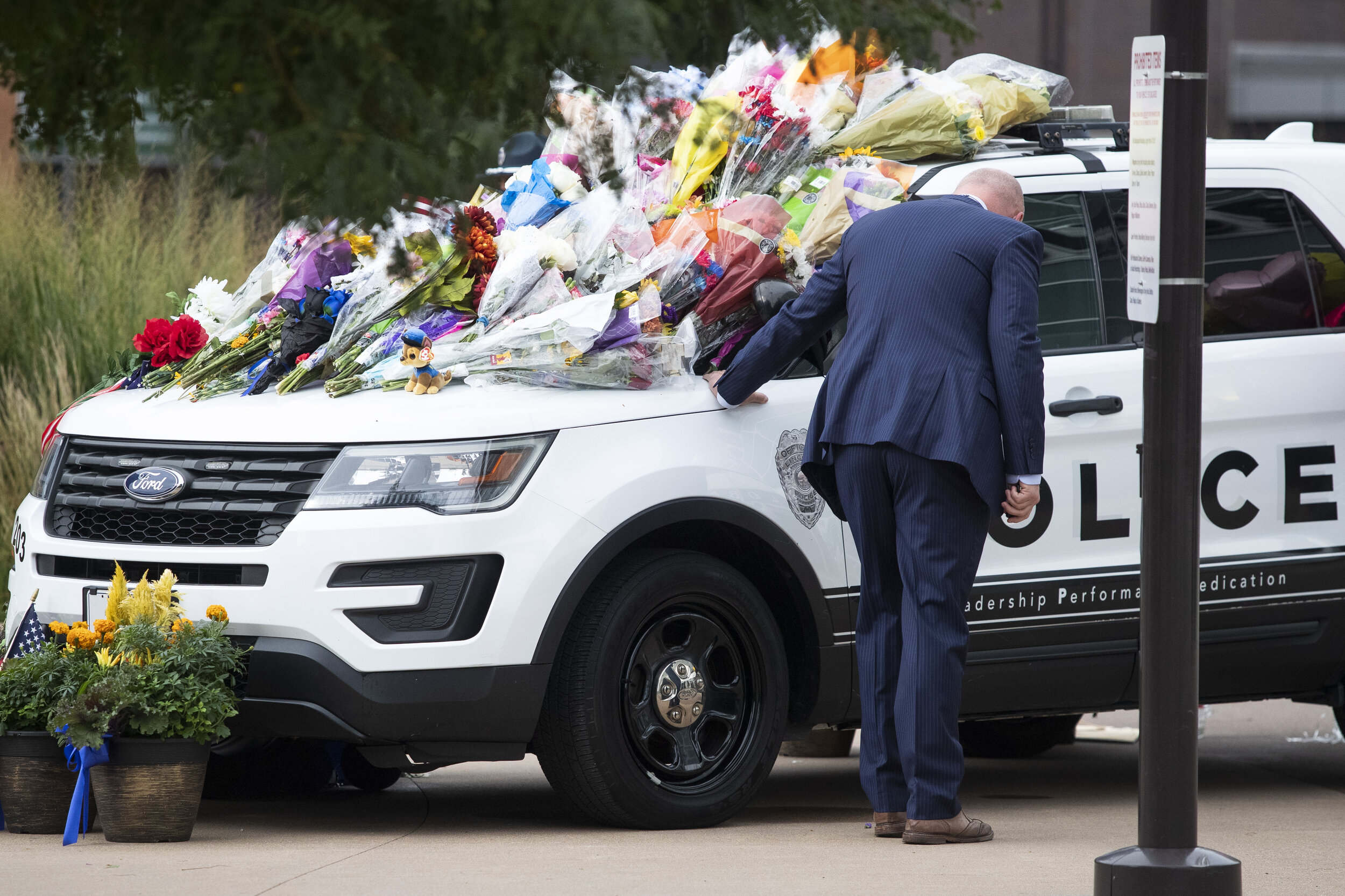  A man places his hand on the LPD cruiser honoring Officer Herrera and takes a moment to himself before he` enters PBA during a funeral ceremony for fallen LPD officer Mario Herrera on Saturday, September 12, 2020, in Lincoln, Nebraska. KENNETH FERRI