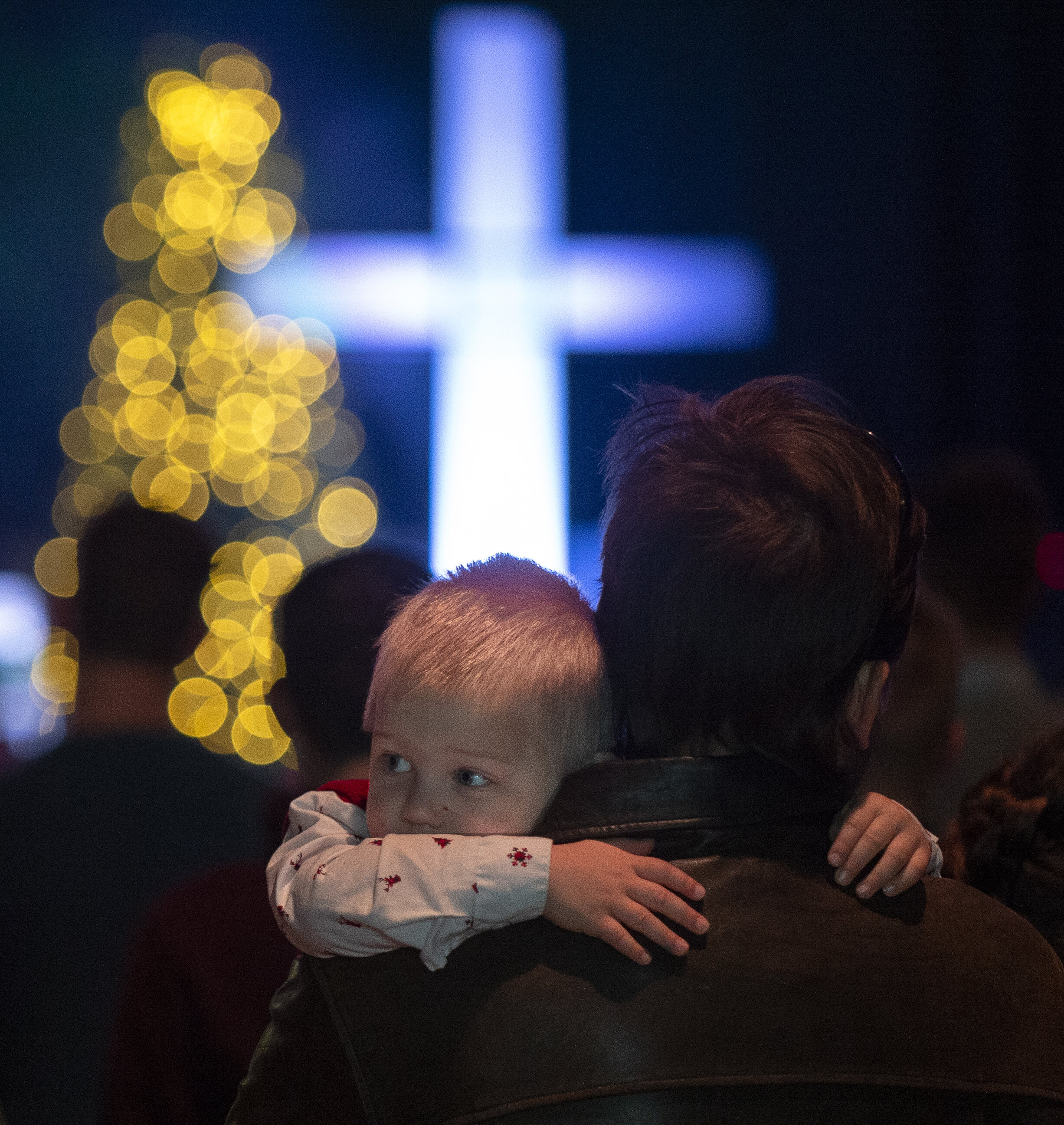  Luke Walker holds on to his father John Walker during a children's service at Christ Lincoln's Yankee Hill Campus on Thursday, December 24, 2020. In a year marked by COVID, churches once again had to make changes to their services.  Some held limite