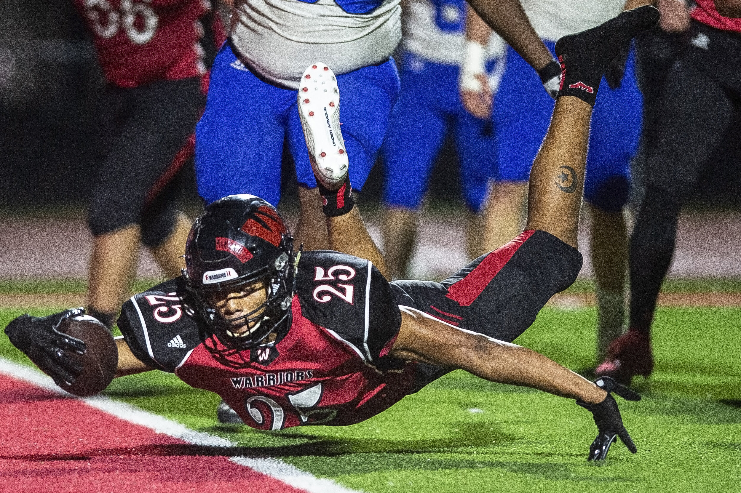   After losing his shoe, Omaha Westside's Koby Bretz dives into the endzone to score a touchdown against Lincoln East during the Class A quarterfinals match on Friday, November 06, 2020, at Omaha Westside High School in Omaha, Nebraska.  KENNETH FERR
