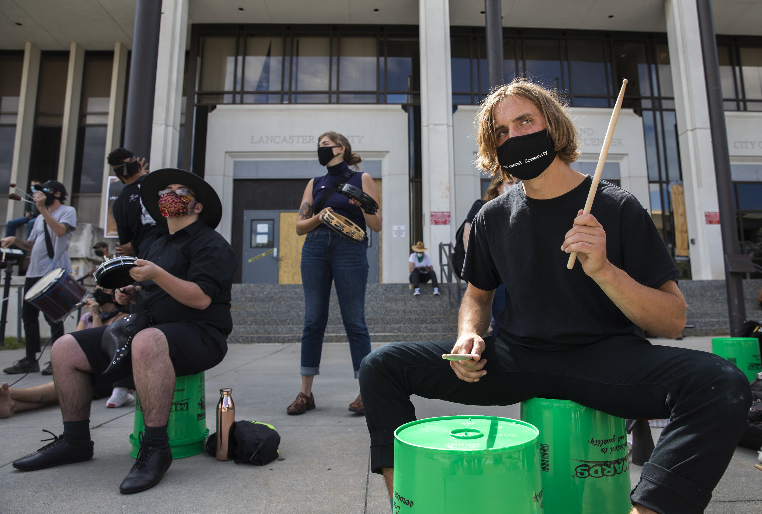  Caleb Petersen (right) uses buckets to drum alongside other protesters during a protest outside of County-City Building while the city council meets inside on Monday, August 03, 2020, in Lincoln, Nebraska. KENNETH FERRIERA, Journal Star. 