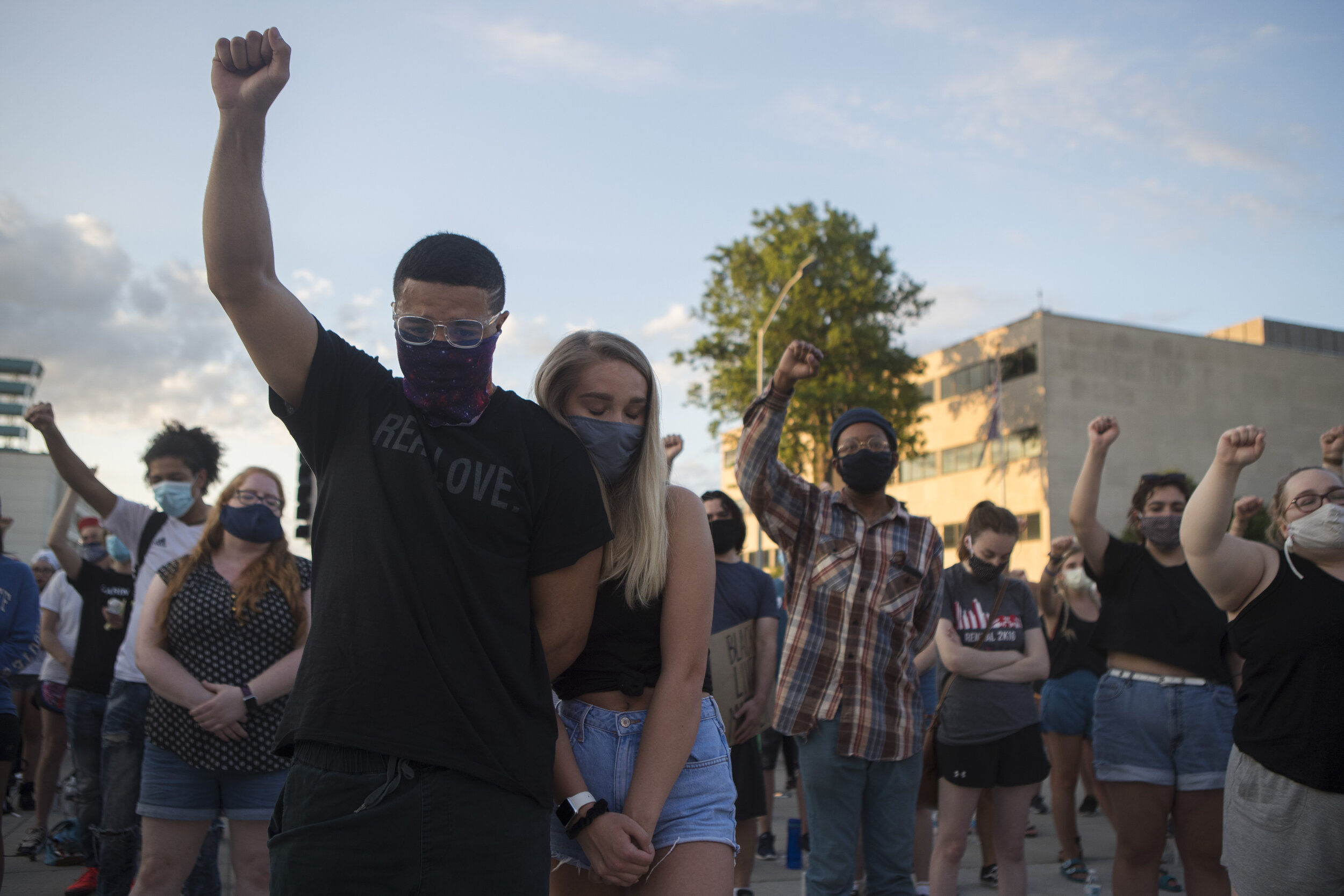  Demetrius Alexander (left) throws up his fist as Taylor Morris leans on him as the crowd sings Amazing Grace during a candlelight vigil remembering those lost on Friday, June 05, 2020, in Lincoln, Nebraska. KENNETH FERRIERA, Journal Star.  