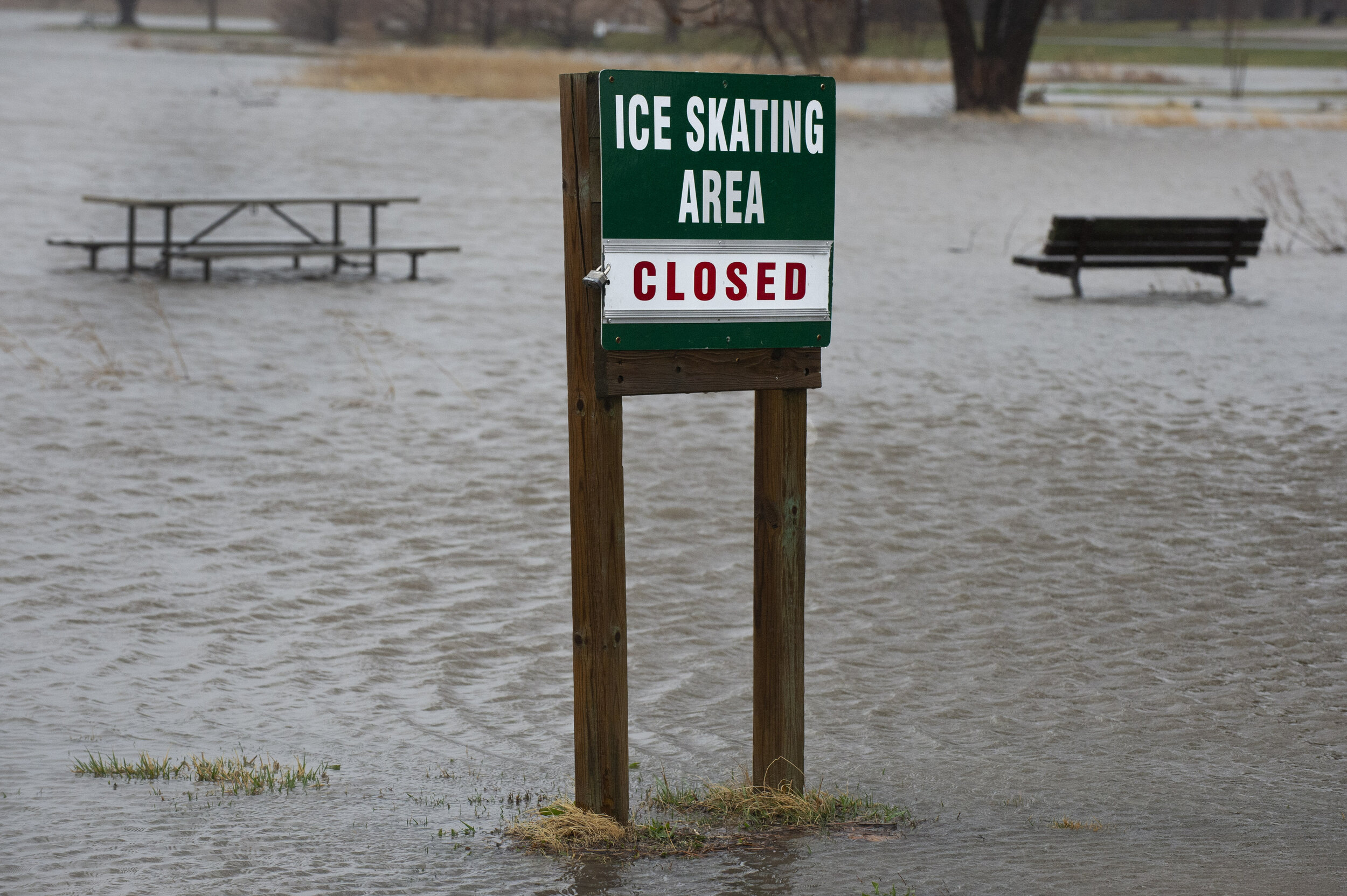  Benches are swallowed by the waters of Holmes Lake as the rain continued to fall, Sunday, March 14, 2021. Spring showers began sweeping through Lincoln late Saturday evening, carrying over into a melancholy Sunday. Rain and strong winds kept many in