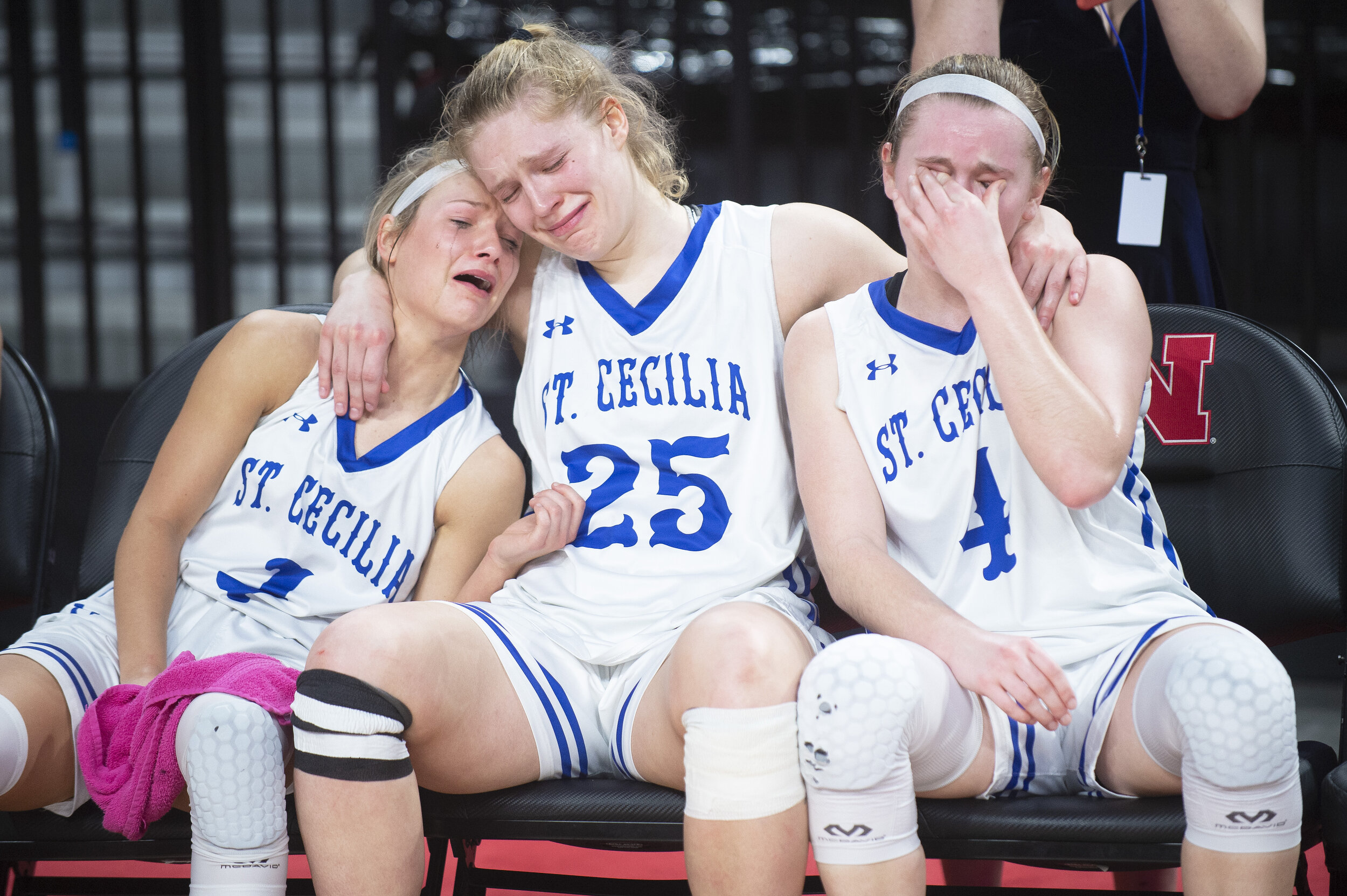  Hastings St. Cecilia's Katharine Hamburger (center) comforts teammates Erin Sheehy (left) and Bailey Kissinger as they wait for the runner-up trophy after losing the Class C1 state championship by a single point on Saturday, March 06, 2021, at Pinna
