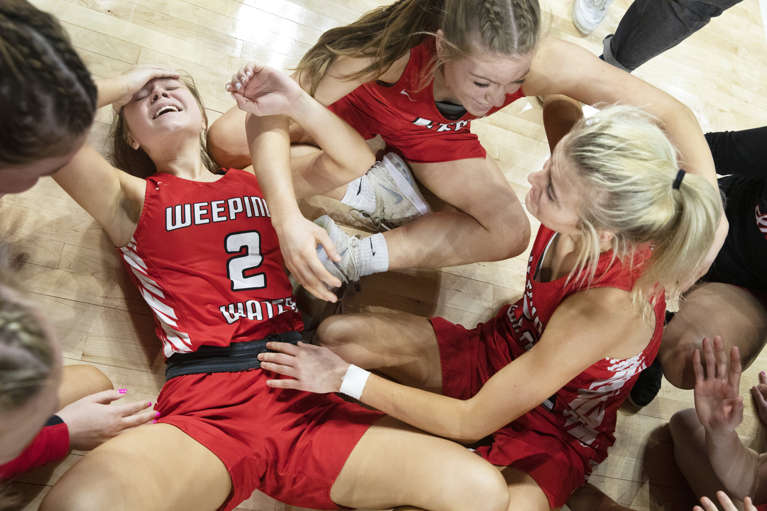  Weeping Water's Jamison Twomey (2) collapses on the floor after a resulting dogpile after winng the Class D1 state championship match against Pleasanton on Saturday, March 06, 2021, at Pinnacle Bank Arena. KENNETH FERRIERA, Journal Star 
