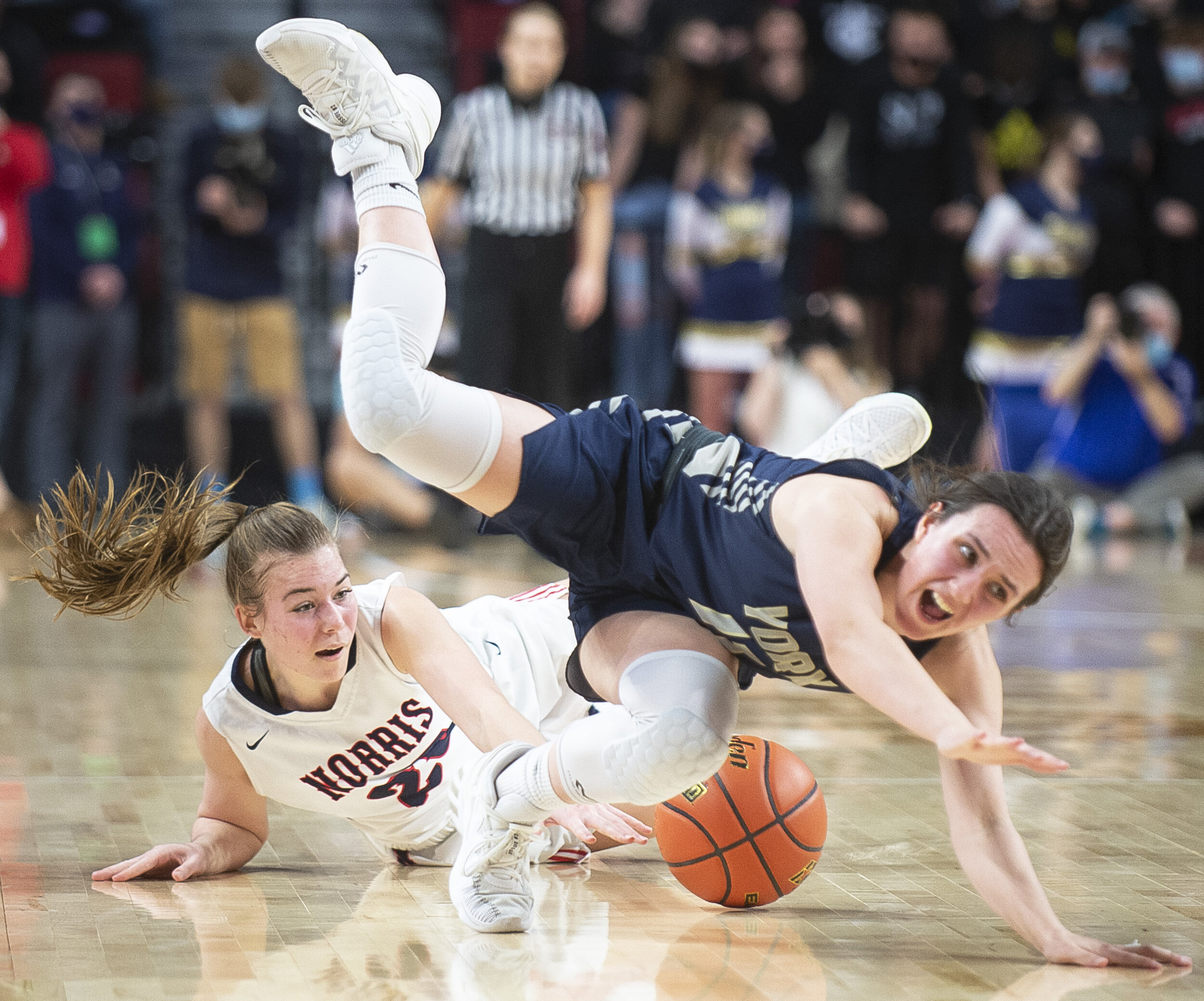  Norris' Maddy Collier (left) collides with York's Destiny Shepherd, sending her tumbling to the floor while diving after a loose ball in the third quarter during a class B semifinal match on Friday, March 05, 2021, at Pinnacle Bank Arena. KENNETH FE