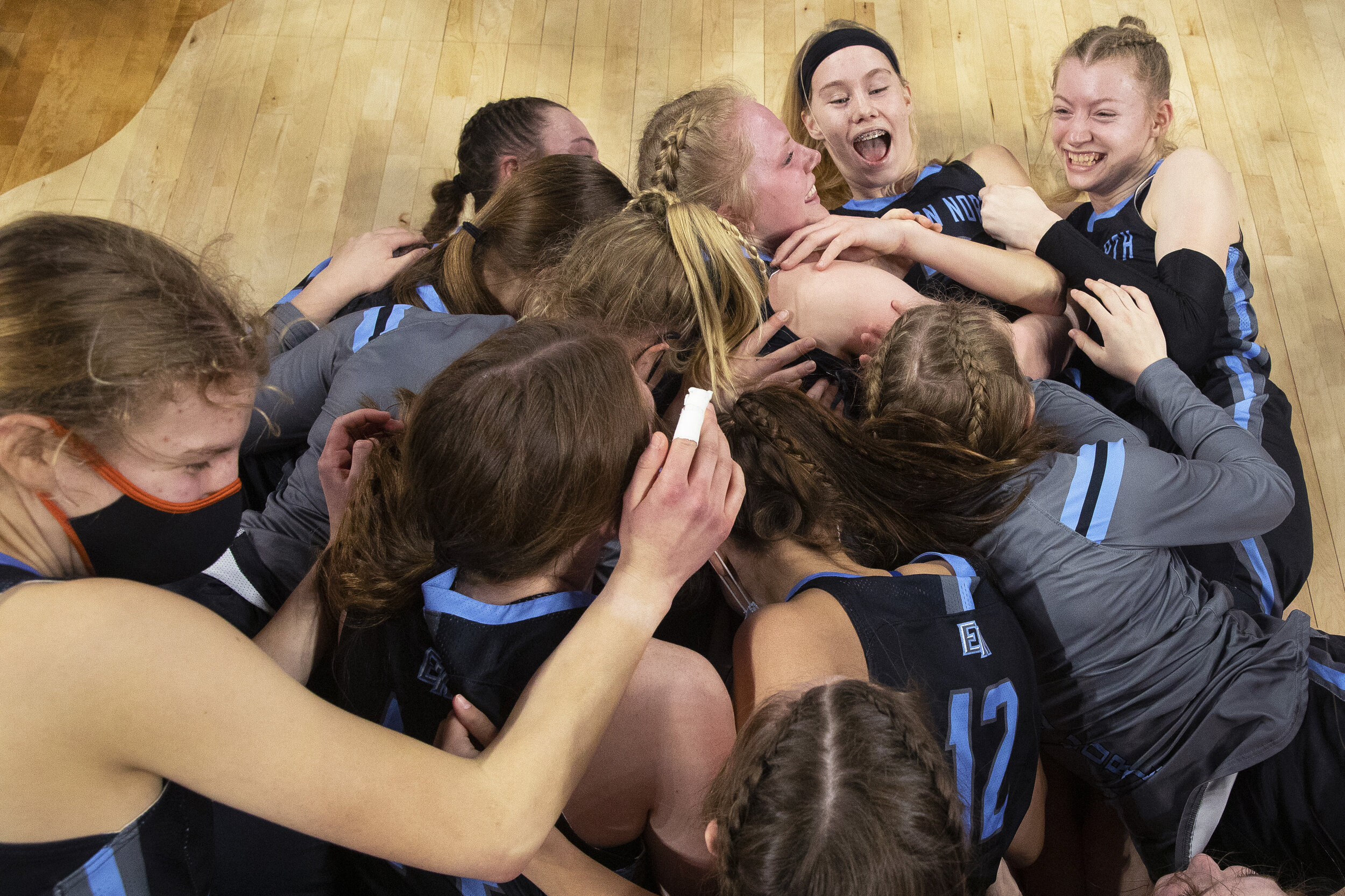  Elkhorn North dogpiles on to Britt Prince (top center) after she led her team to their first-ever state championship in school history during the Class B state championship match on Saturday, March 06, 2021, at Pinnacle Bank Arena. KENNETH FERRIERA,