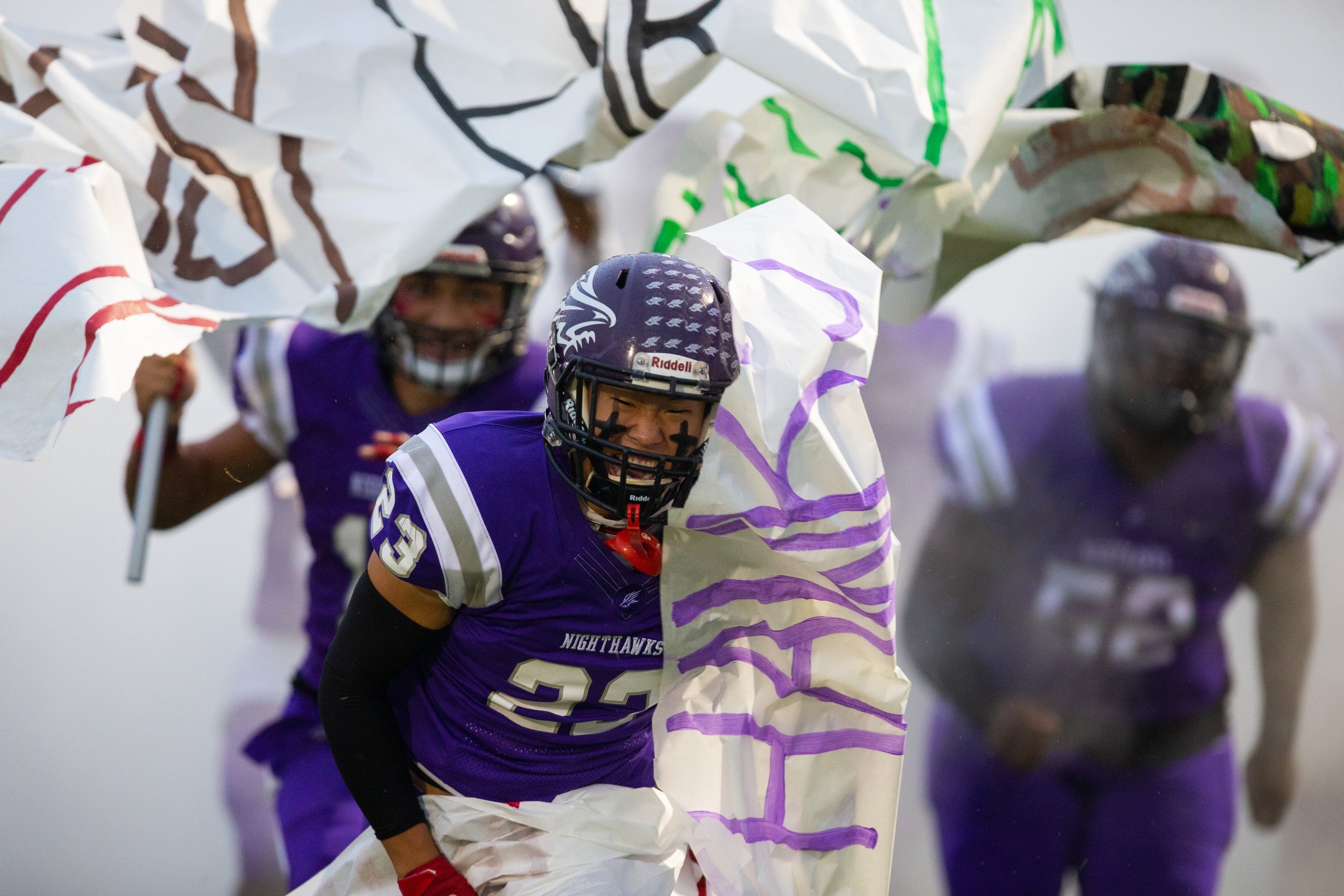  Northern's Carston Lee breaks through a paper banner as the Northern football team takes the field before the game against Northwest at Northern Guilford High School in Greensboro, N.C., on Friday, October 8, 2021.   