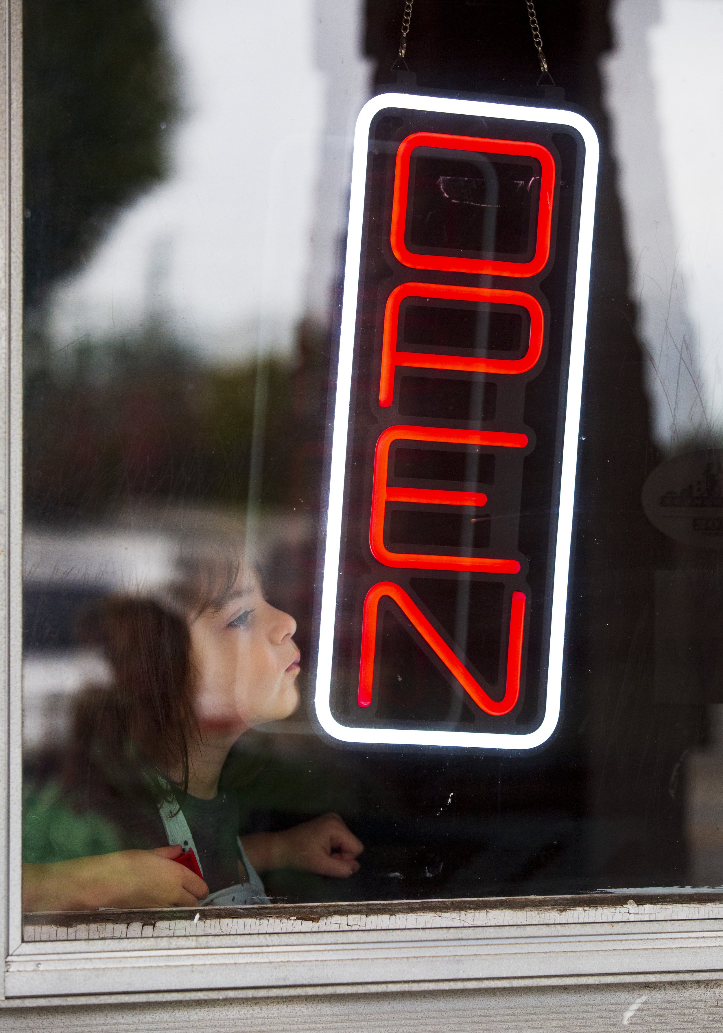  Armina Lemo presses her face against the window at the Local Roots Coffee Shop in Kernersville, N.C., on Thursday, September 16, 2021.   