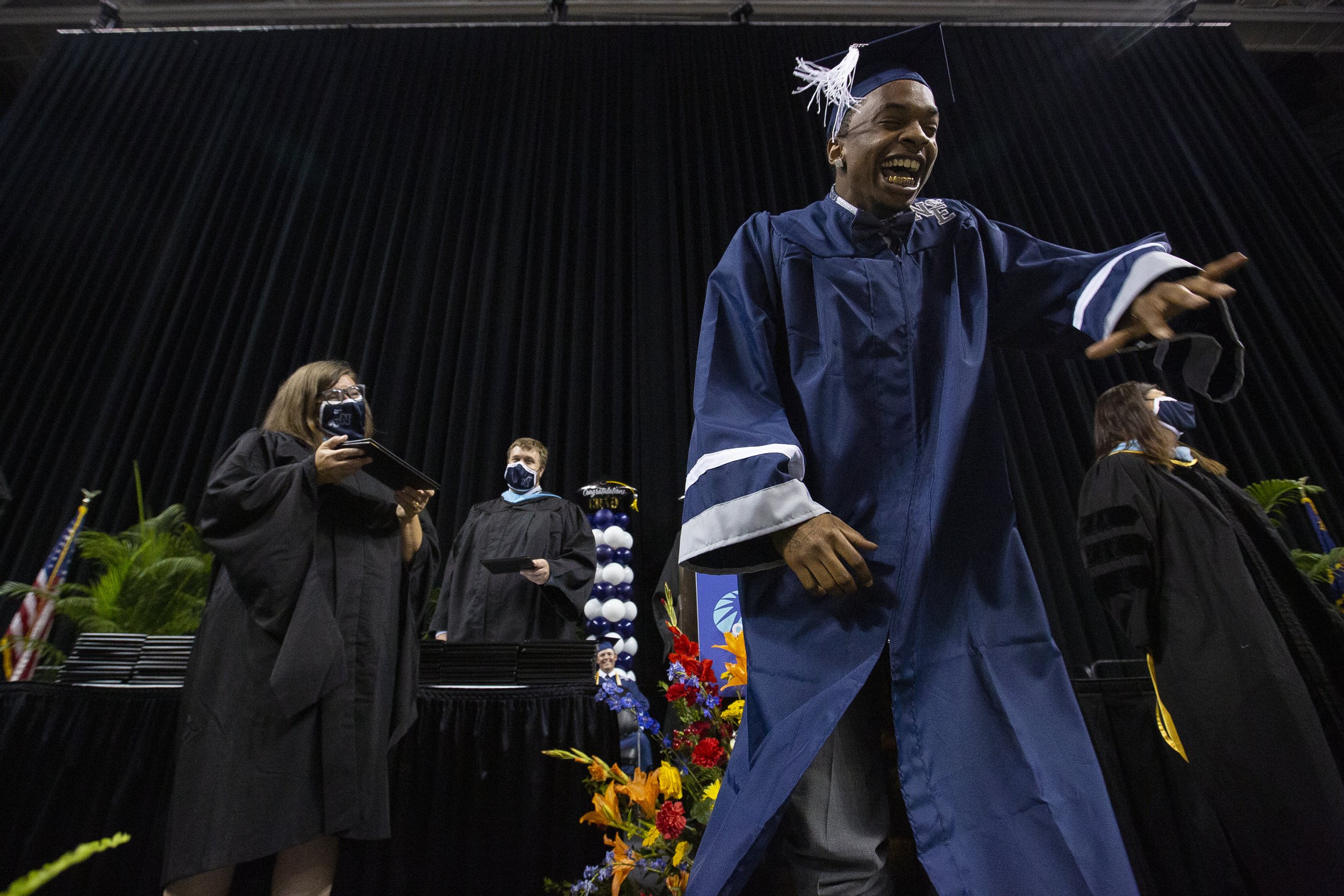  Demangio Rivers (right) dances before receiving his high school diploma during a graduation ceremony for Northeast High School at the Greensboro Coliseum in Greensboro, N.C., on Saturday, June 5, 2021.  
