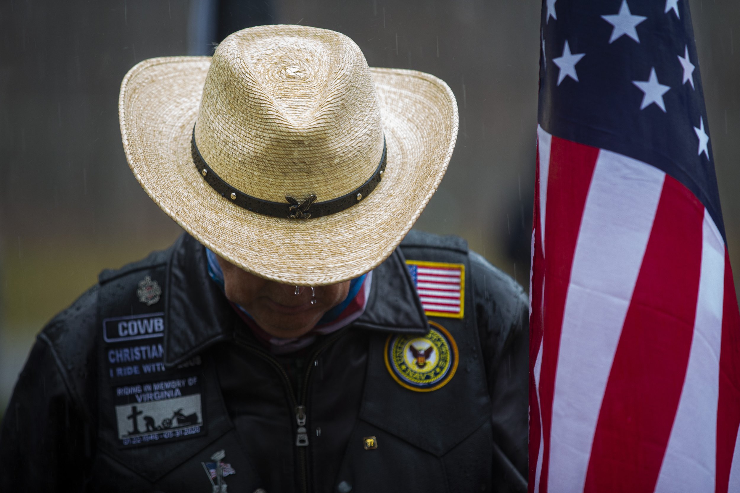  Rain drops fall from the brim of a hat worn by a Member of the American Family Riders as a sudden downpour descends on the crowd during a wreath laying ceremony held by Wreathes Across America at Forest Lawn Cemetery in Greensboro, N.C., on Saturday