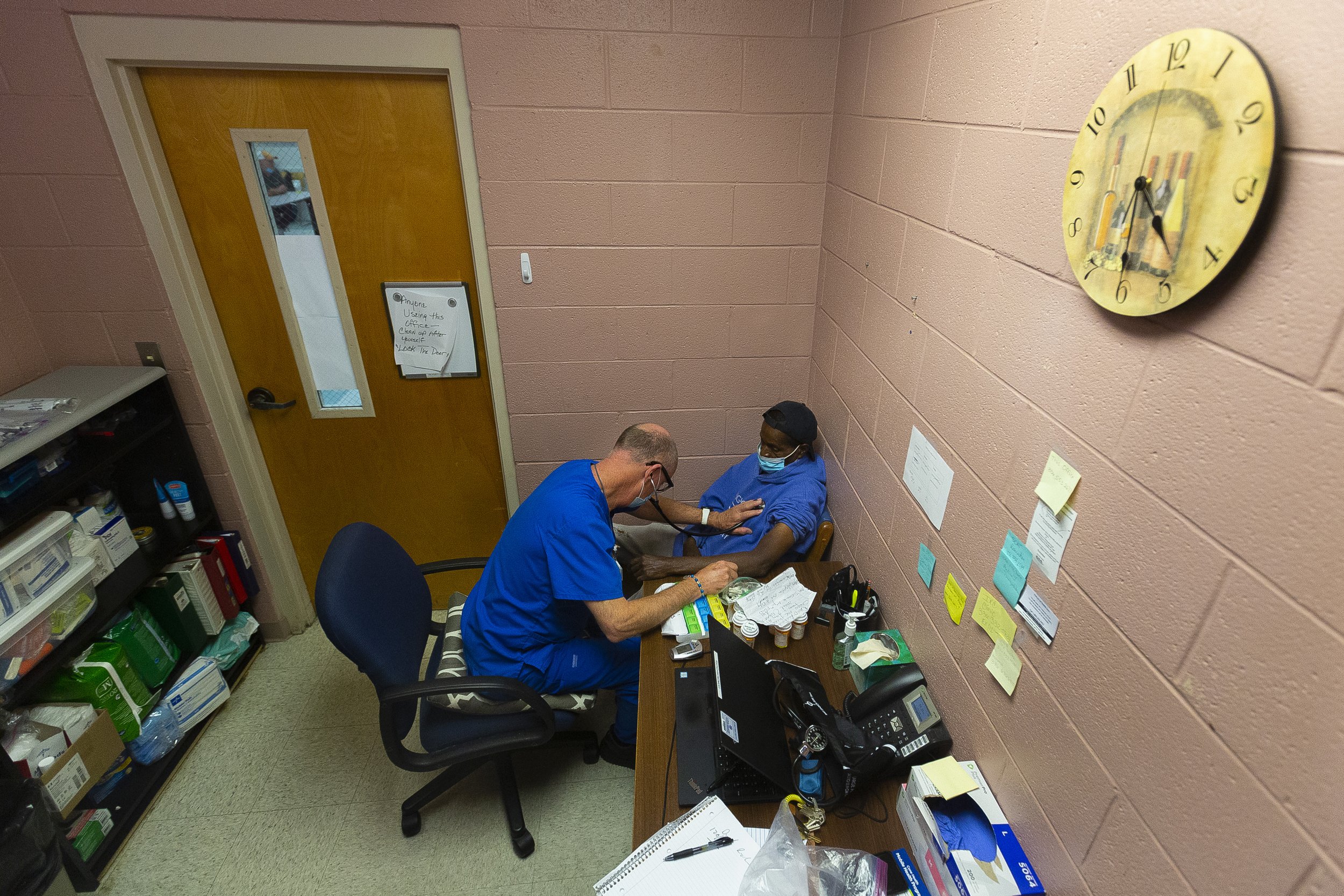  Dr. Patrick Wright uses his stethoscope to listen to David Richardson's heart during a weekly checkup during walk-in clinic at the Greensboro Urban Ministry in Greensboro, N.C., on Wednesday, August 4, 2021. 