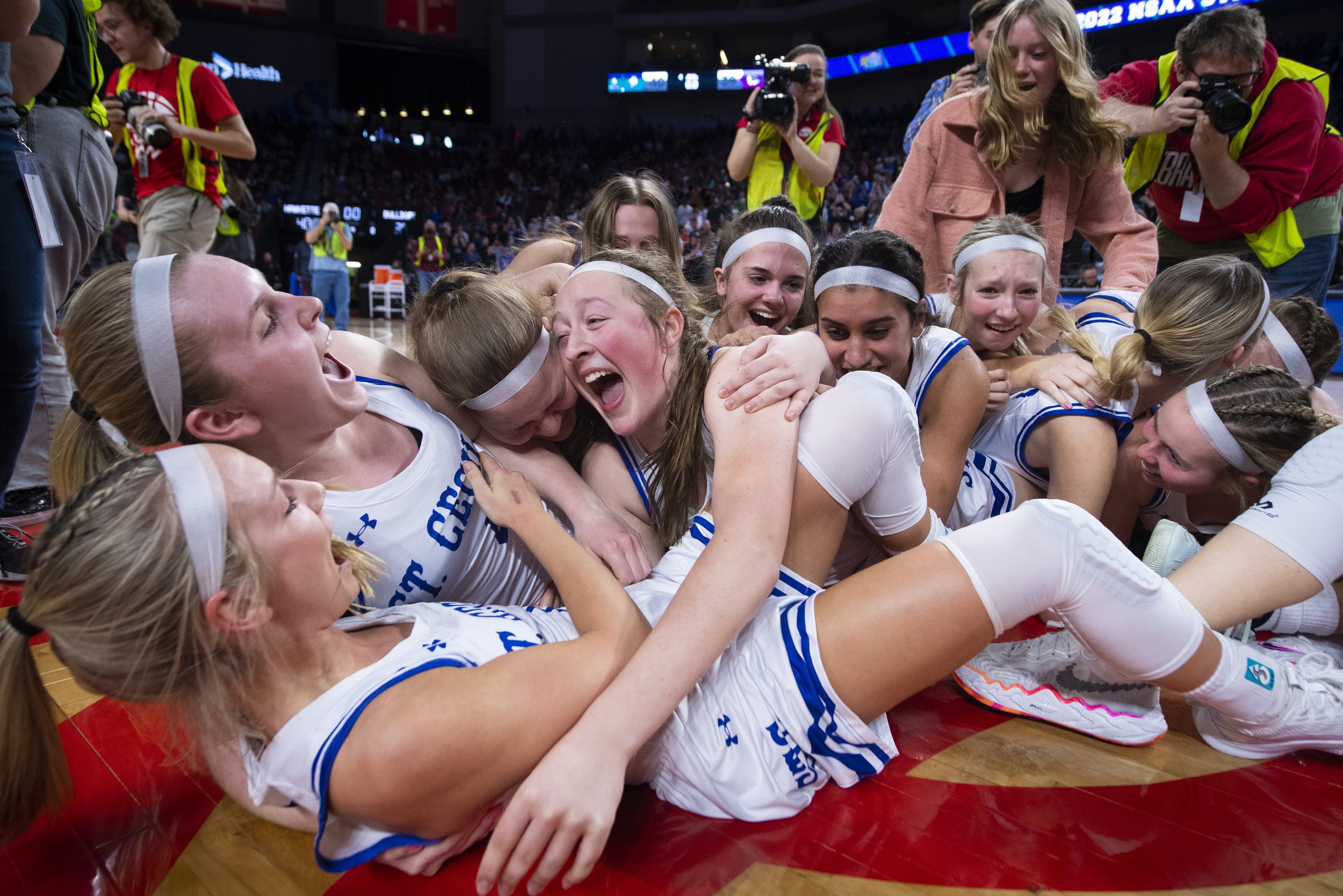  Hastings SC's Erin Sheehy(bottom left) is dog pilled by her team at the center of the court after they defeated Bridgeport during the Class C-2 girls championship at Pinnacle Bank Arena on March 12, 2022, in Lincoln, Nebraska. 