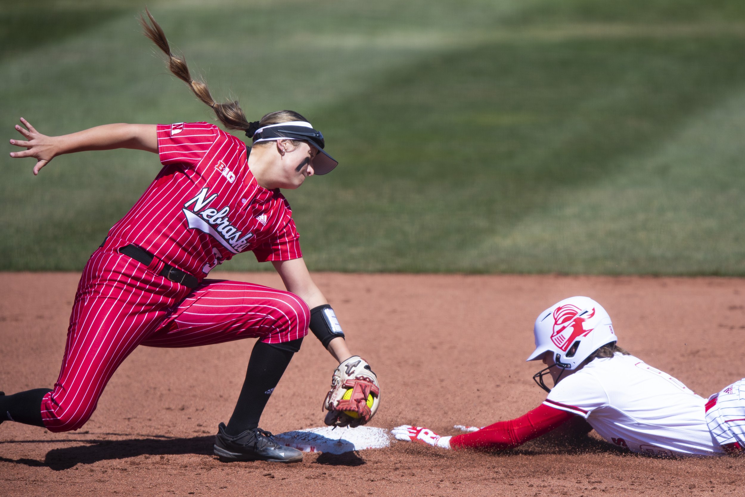  Nebraska second basemen Cam Ybarra  (left) tries but fails to make the tag on Rutgers baserunner Taylor Fawcett during an attempt to steal second base during the second inning at Bowlin Stadium on April 2, 2022, in Lincoln, Nebraska.  