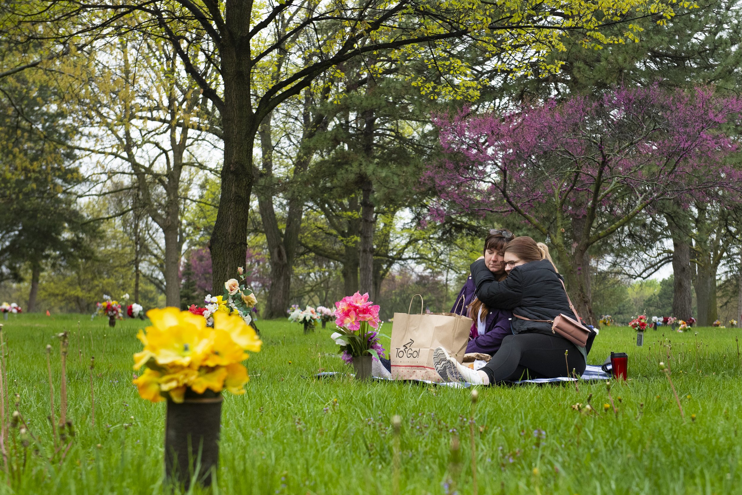  Christine Scott (left) hugs her daughter Keisha Scott as they have a picnic of Burger King breakfast sandwiches at the grave of Christine's mother and father, Susan and Ted Hegwald, at Wyuka Cemetery on Mother's Day, May 8, 2022, in Lincoln, Nebrask