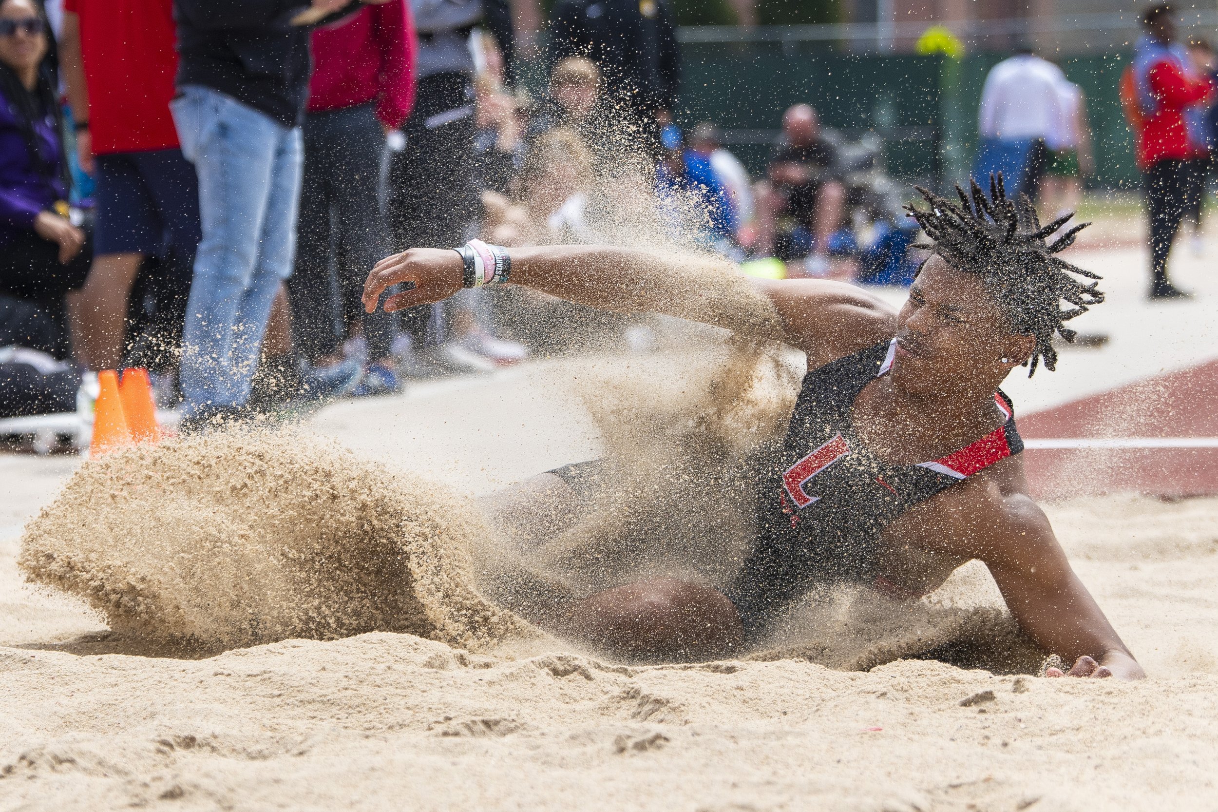  Lincoln High's Adonis Hutchinson lands in the sand pit after being called for a foul  while competing in the boys long jump the at Beechner Athletic Complex on April 21, 2022, in Lincoln, Nebraska. KENNETH FERRIERA, Journal Star       