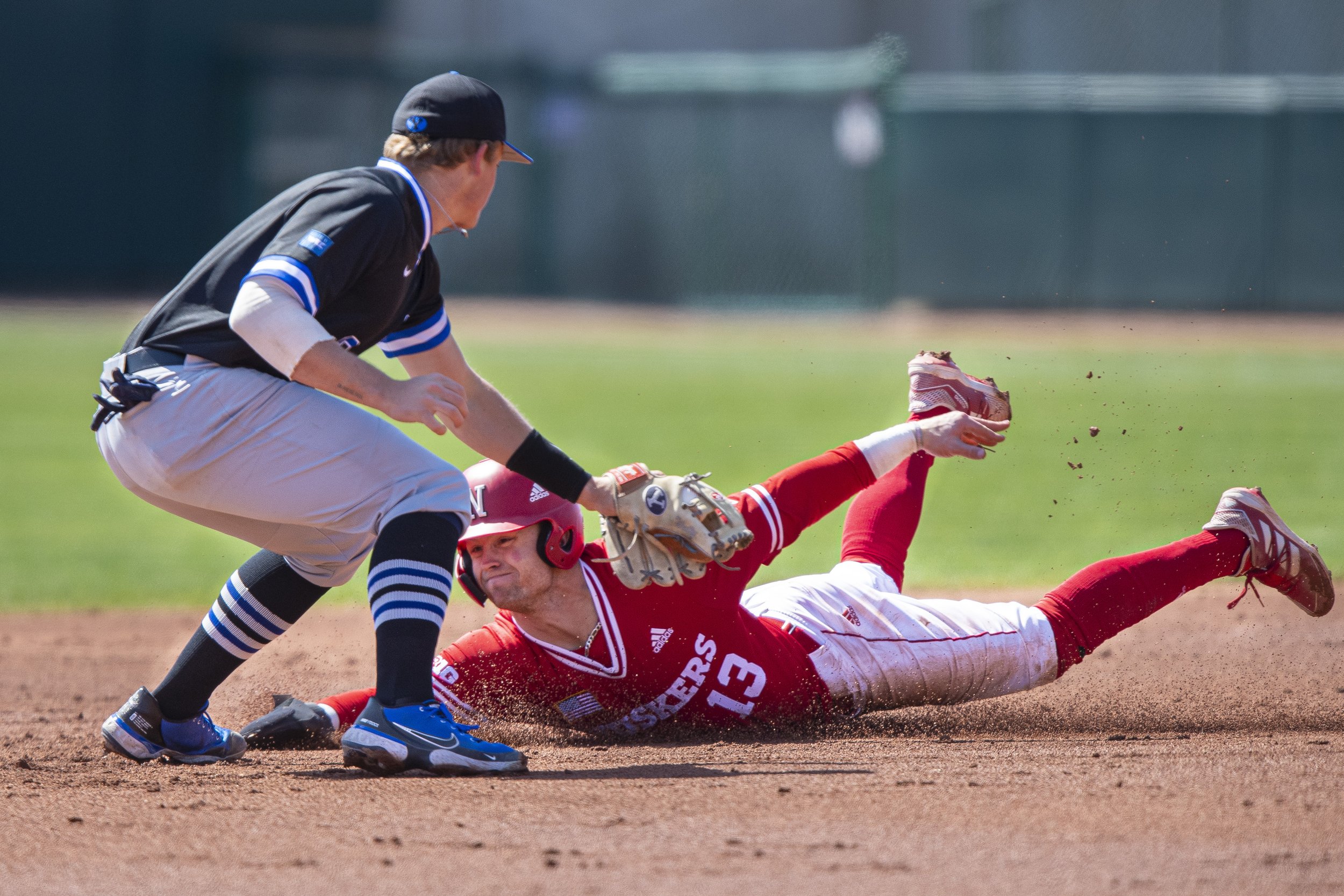  Nebraska baserunner Cam Chick is tagged out by BYU second basemen Ozzie Pratt while attempting to steal  second base during the third inning at Haymarket Park on April 16, 2022, in Lincoln, Nebraska 