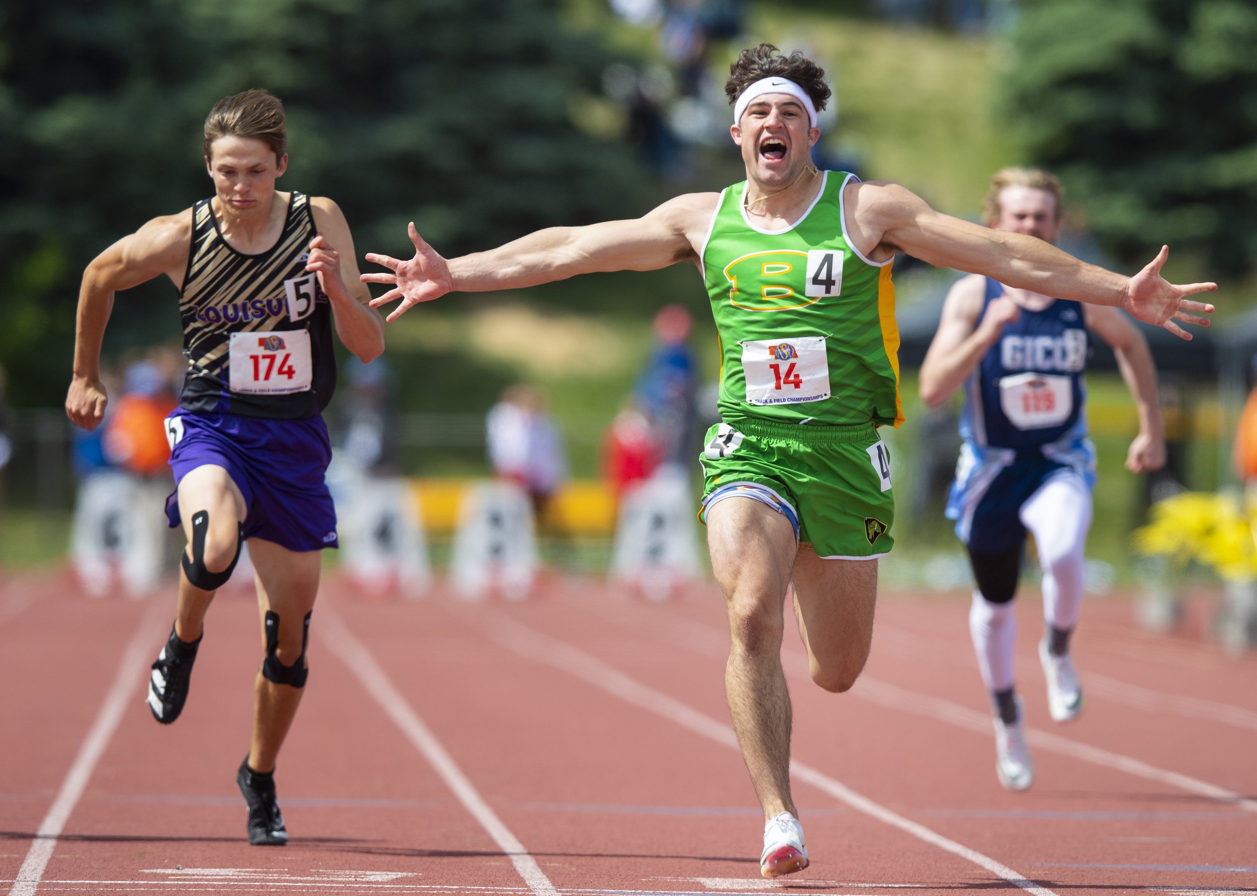  Arch Bishop's Koa McIntyre celebrates as he crosses the finish line in the Class C boys 100 meter dash during the state track championships at Burke Stadium on May 21, 2022, in Omaha, Nebraska 
