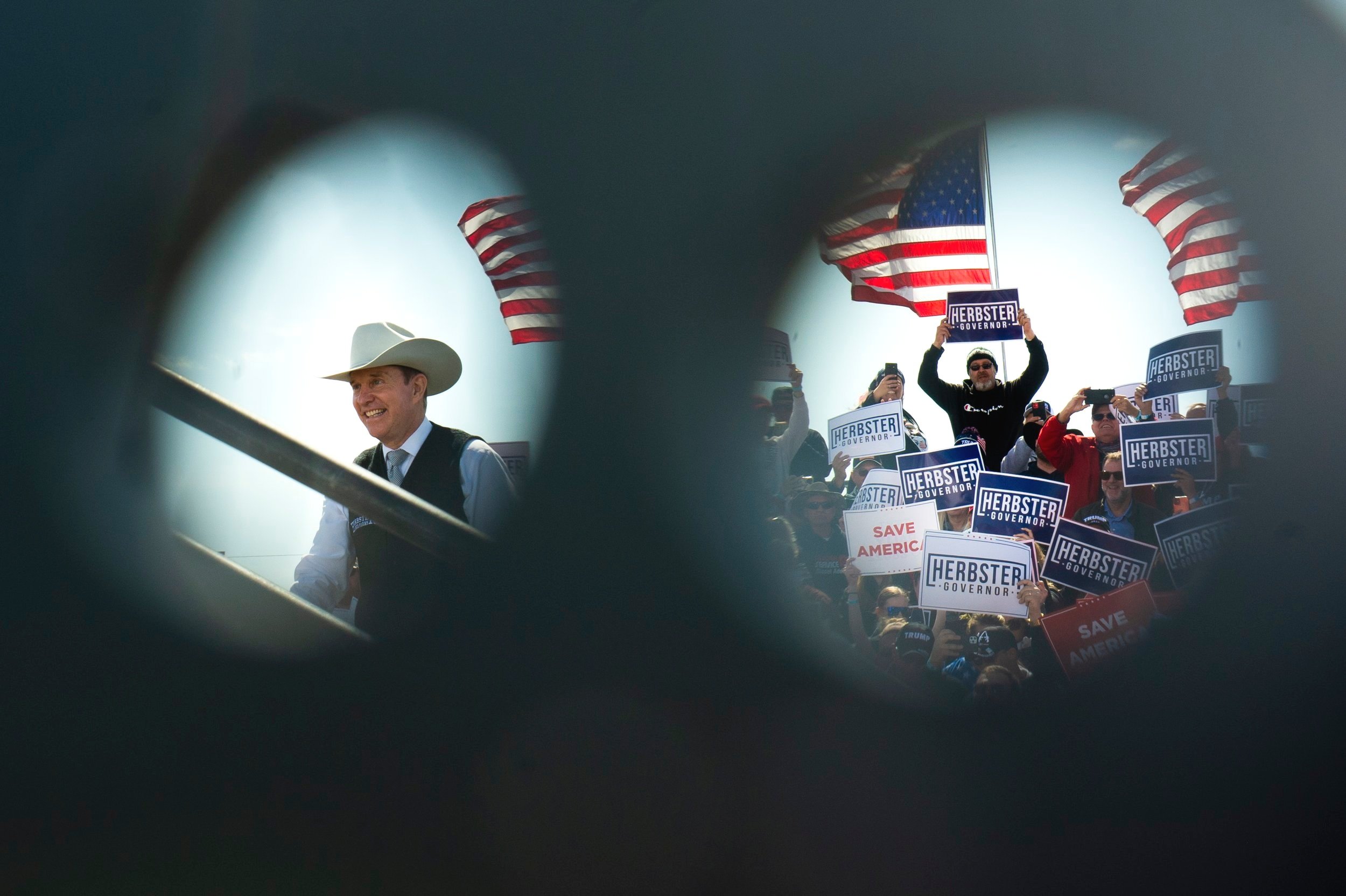  As seen through open cable holders, avid supporters of Gubernatorial candidate Charles Herbster and former president Donald Trump cheer as Herbster takes the stage during a Trump rally for Charles Herbster at the I-80 Speedway on May 1, 2022, in Gre