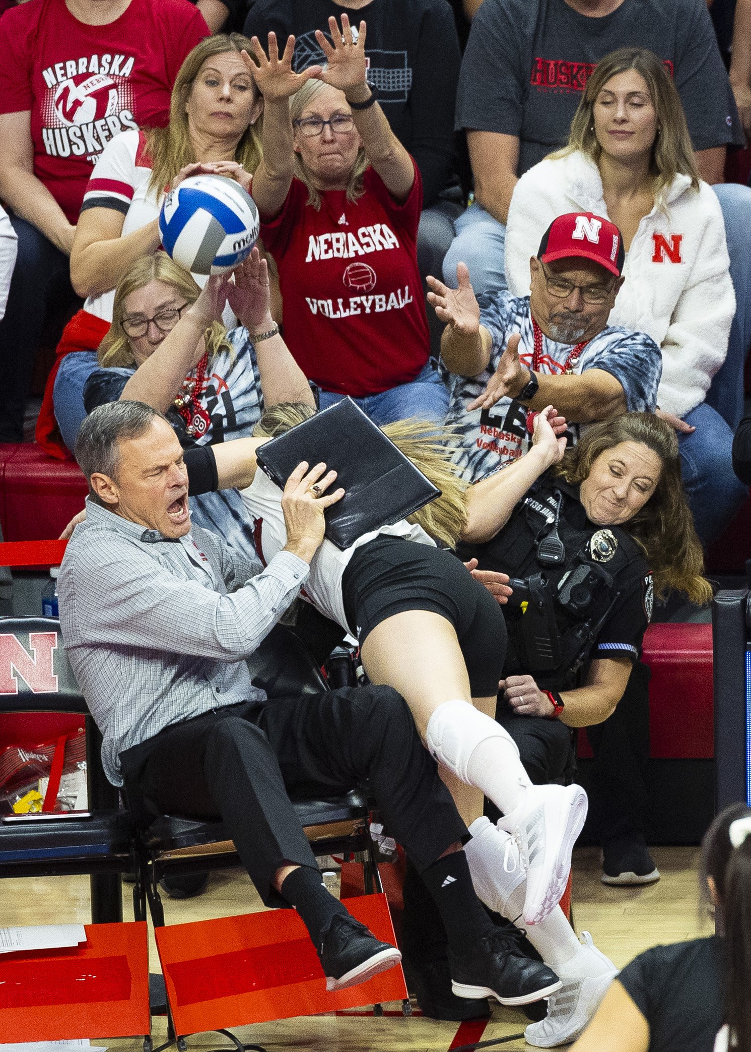  Nebraska's Laney Choboy (6) dives into head coach John Cook as she tries to save the ball from going out of bounds in the third set, during an NCAA Regional Semifinal match held at the Bob Devaney Sports Center, on Thursday, Dec. 7, 2023, in Lincoln
