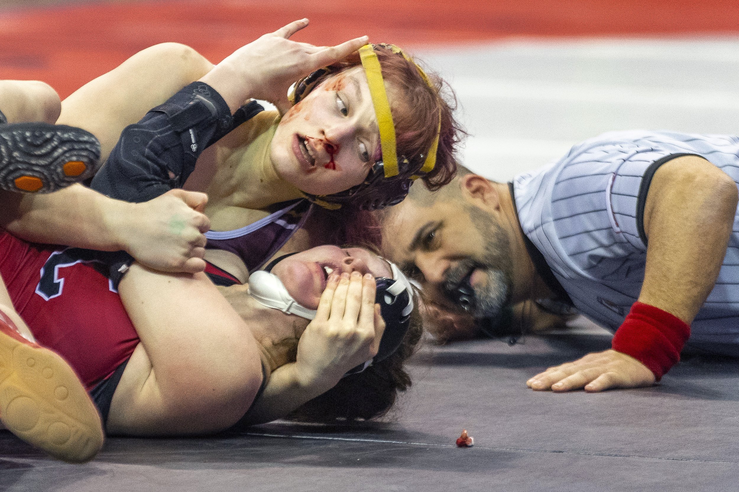  Blood smears the face of Chadron's Kenli Boeselager as she wrestles on the mat against Conestoga's Maggie Fiene during a 145 lb semifinal match on Friday, Feb. 17, 2023, at CHI Health Center in Omaha. 