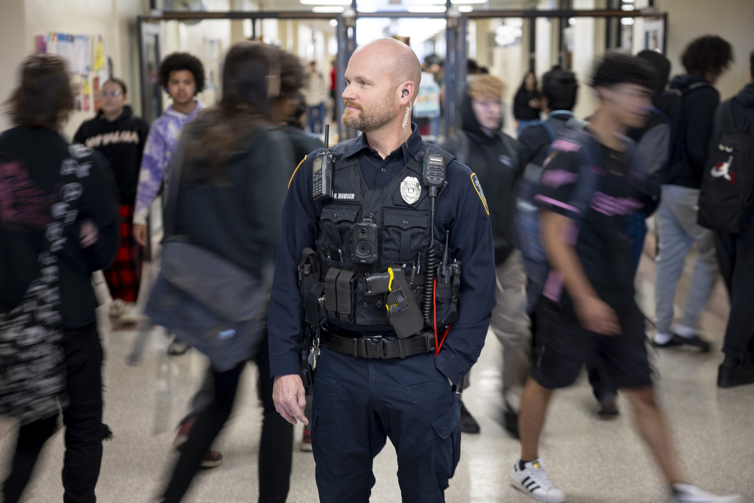  Lincoln High School SRO Ofc. Nolan Hauser stands in the hallway during a passing period to direct hallway traffic at Lincoln High School, on Thursday, Feb. 15, 2024. 