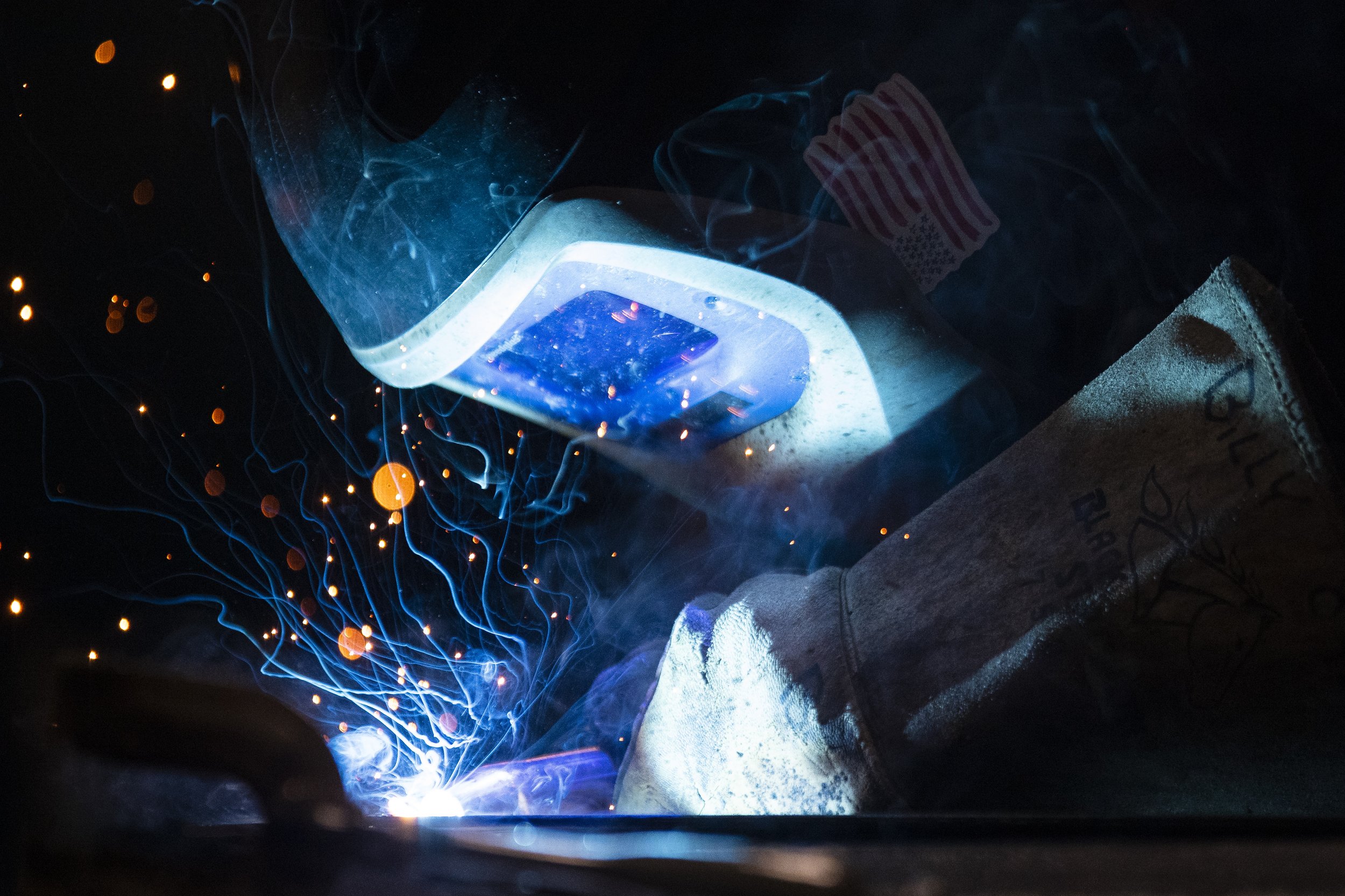  Sparks and smoke rise from a the workbench where Lincoln East senior Blake Allen welds together two pieces of metal on Wednesday, April 12, 2023, at The Career Academy in Lincoln. 