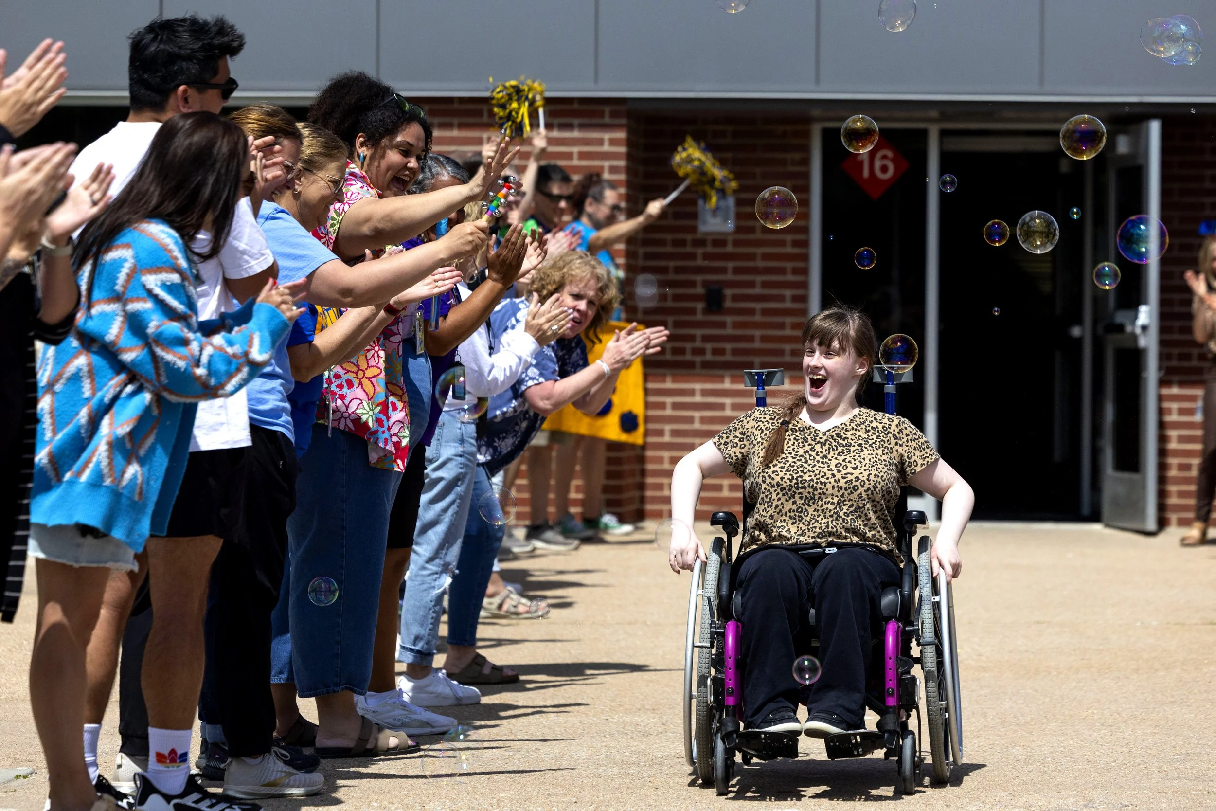  Graduating 8th grader Rose Lorenz (right) reacts as she is cheered on by teachers and school staff outside of Lefler Middle School after students were dismissed for summer break on Thursday, May 22, 2025, in Lincoln.  Lefler Middle School's annual t