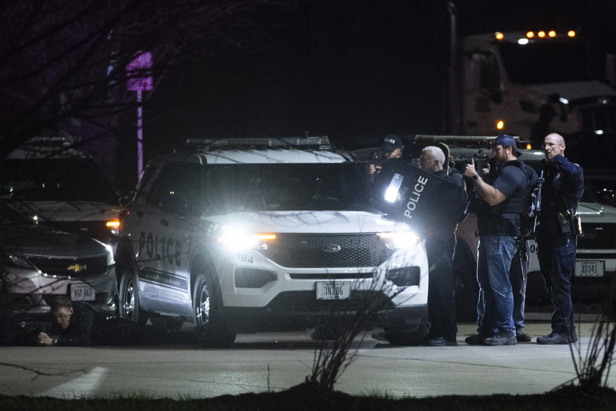  Police take cover during standoff at a Casey's on 2500 Northwest 12th stree on Tuesday, April 2, 2024, in Lincoln. 