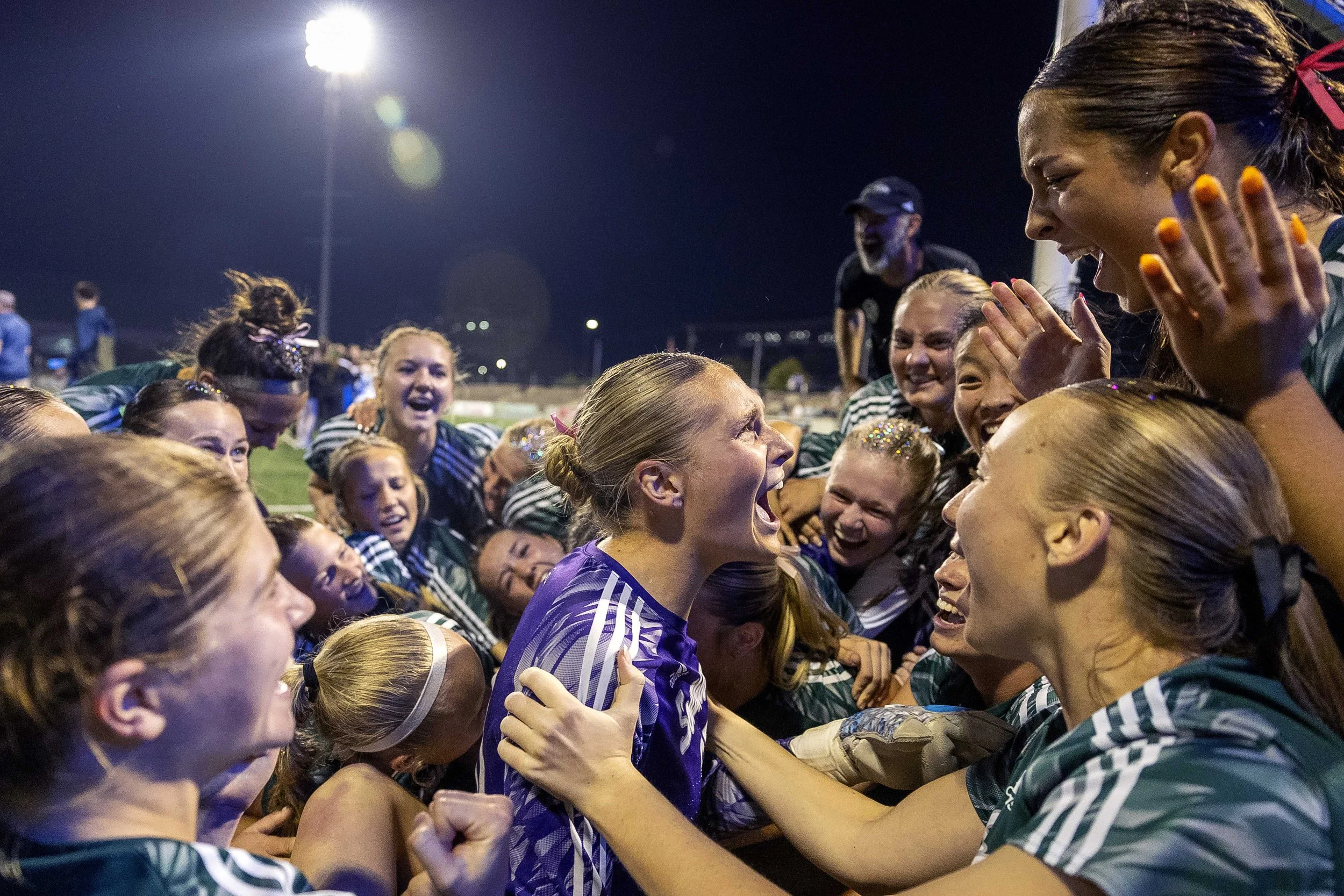  Lincoln Southwest's Clara Fundus (center) is dogpiled by her team as they celebrate defending the goal during an overtime shootout win over Pius X of the Class A girls state soccer tournament championship on Monday, May 13, 2024, at Morrison Stadium