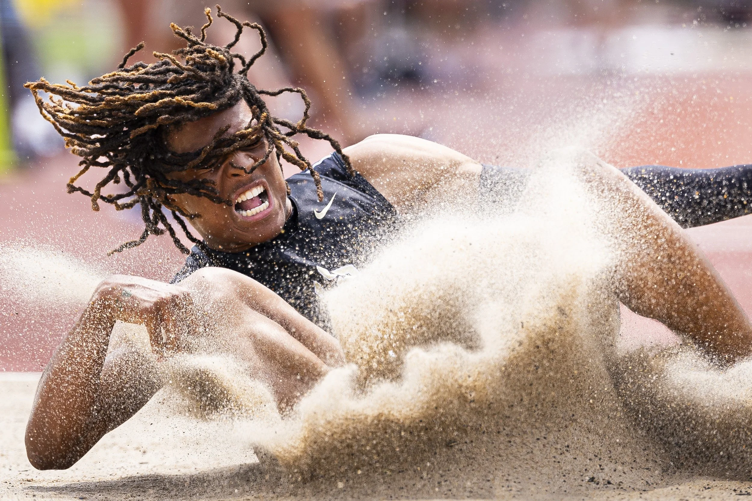 Lincoln Southeast's Davieian Williams lands in the sandpit while competing in the boys triple jump during the first day of Class A & B state track at Omaha Burke Stadium on Wednesday, May 15, 2024.