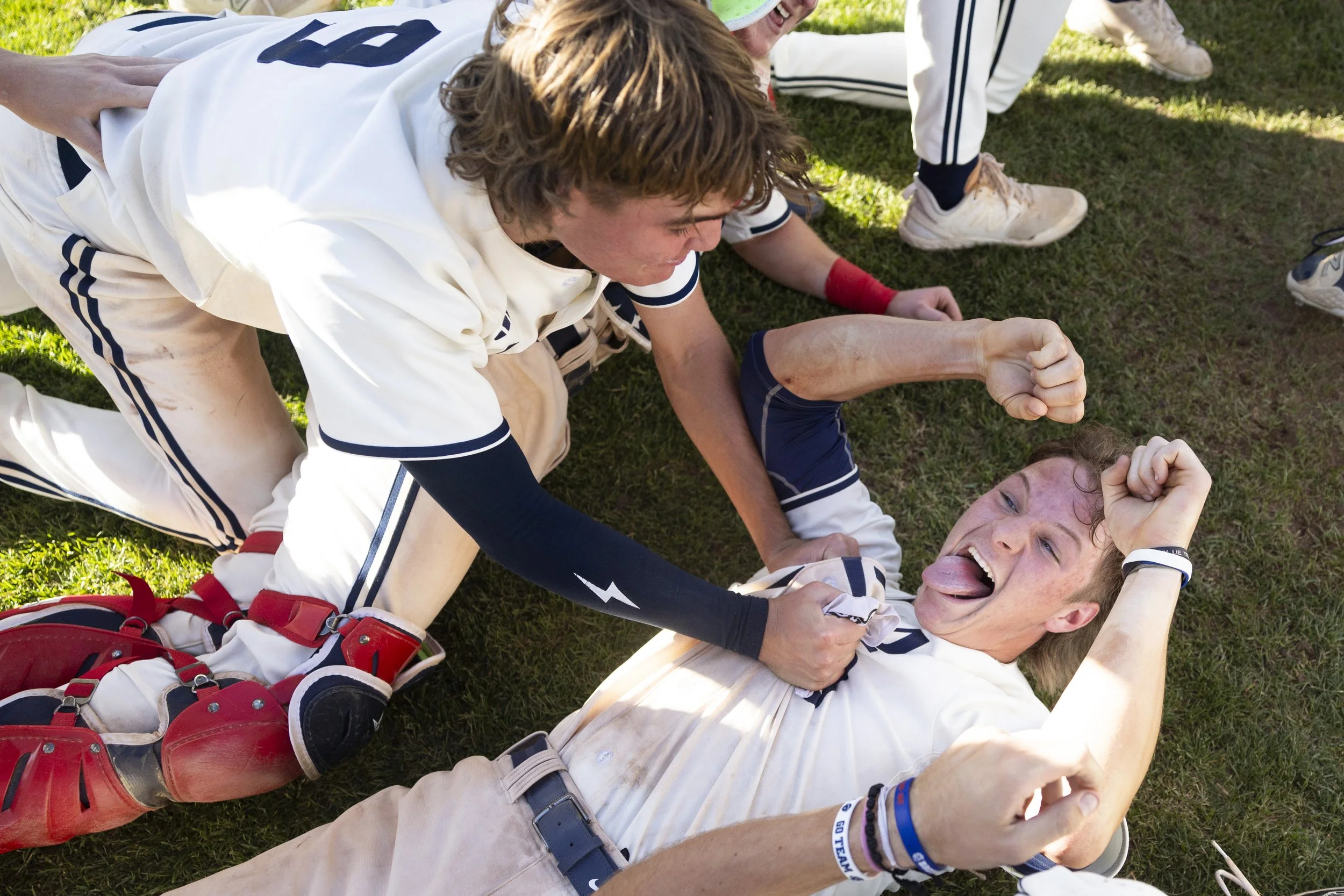  Norris' Crew Moeller (right) sticks out his tongue as he is pulled from the bottom of the dogpile by Alec Small (9) after winning the Class B state championship on Friday at Werner Park. 