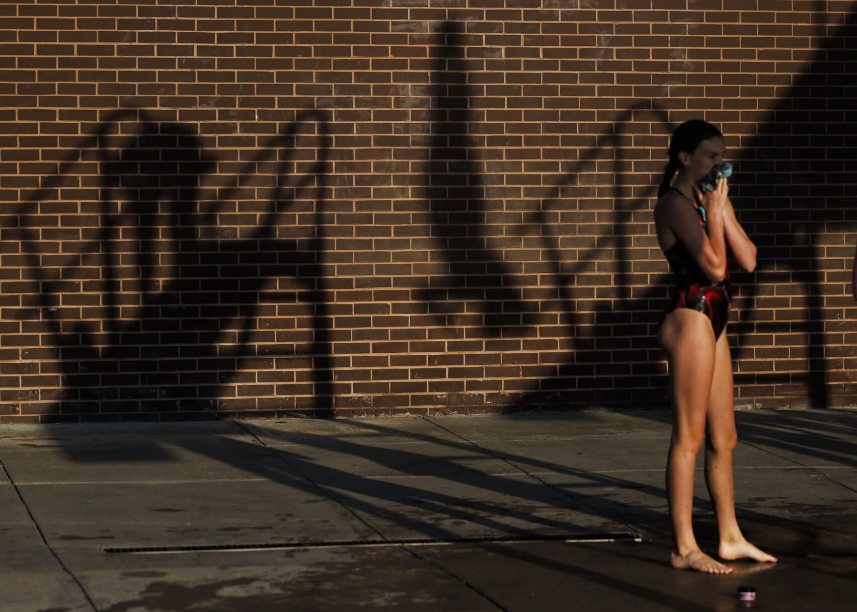  Shadows of athletes are cast on the wall as they warm up on the diving board during the Cornhusker State Games diving competition at Woods Memorial Pool on Saturday, July 13, 2024, in Lincoln. 