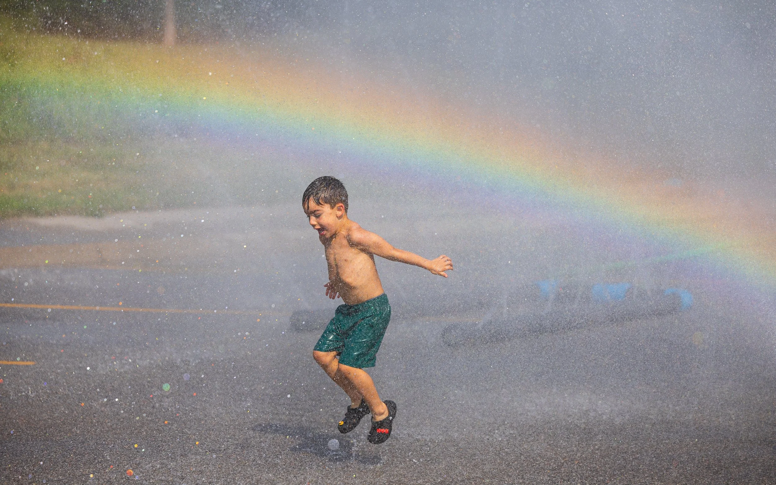 Jasper Gonzalez plays in the water from a sprinkler during the cities first ever hydrant party at Densmore Park on Monday, Aug. 10, 2026, in Lincoln.