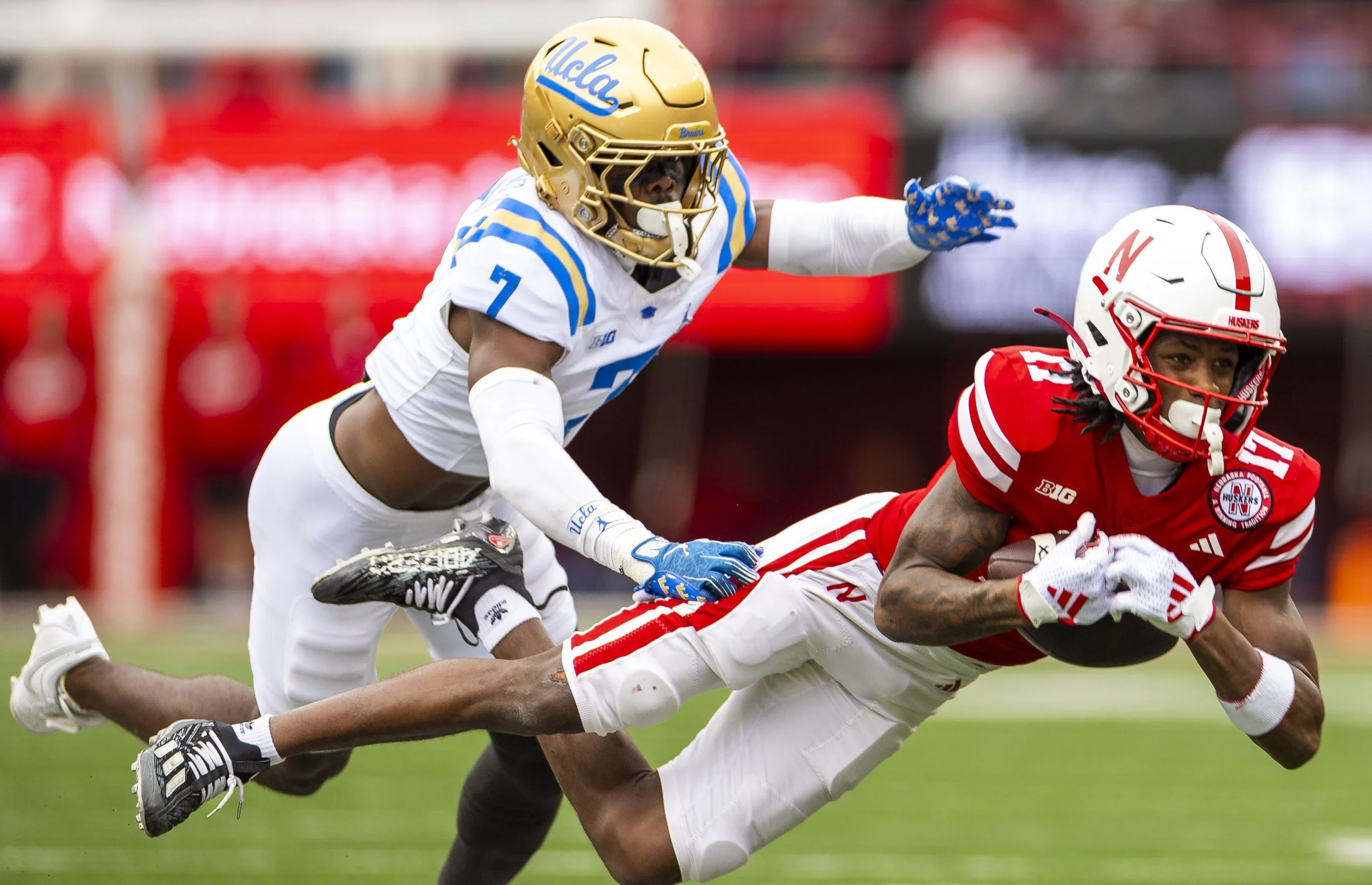 UCLA's K.J. Wallace (7) defends Nebraska's Jacory Barney (17) as he makes a diving 40-yard catch in the second quarter on Saturday, Nov. 2, 2024, at Memorial Stadiu