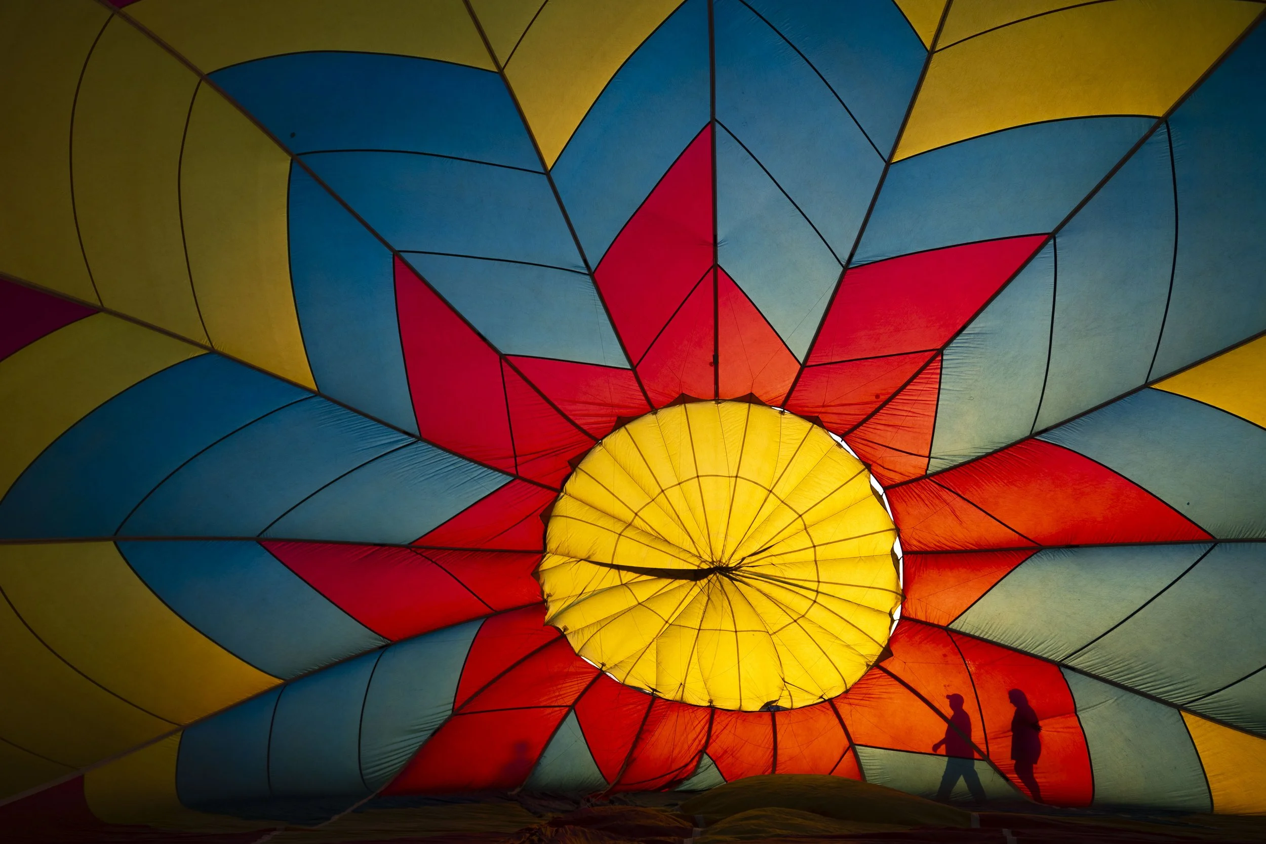 Tony Goodnow, first right, and Samantha Hendrix check the integrity of the balloon "Hocus Pocus" before taking part in the Balloon glow during the Hot Air Balloon Festival on June 13, 2025 at Brenner Field in Falls City.

